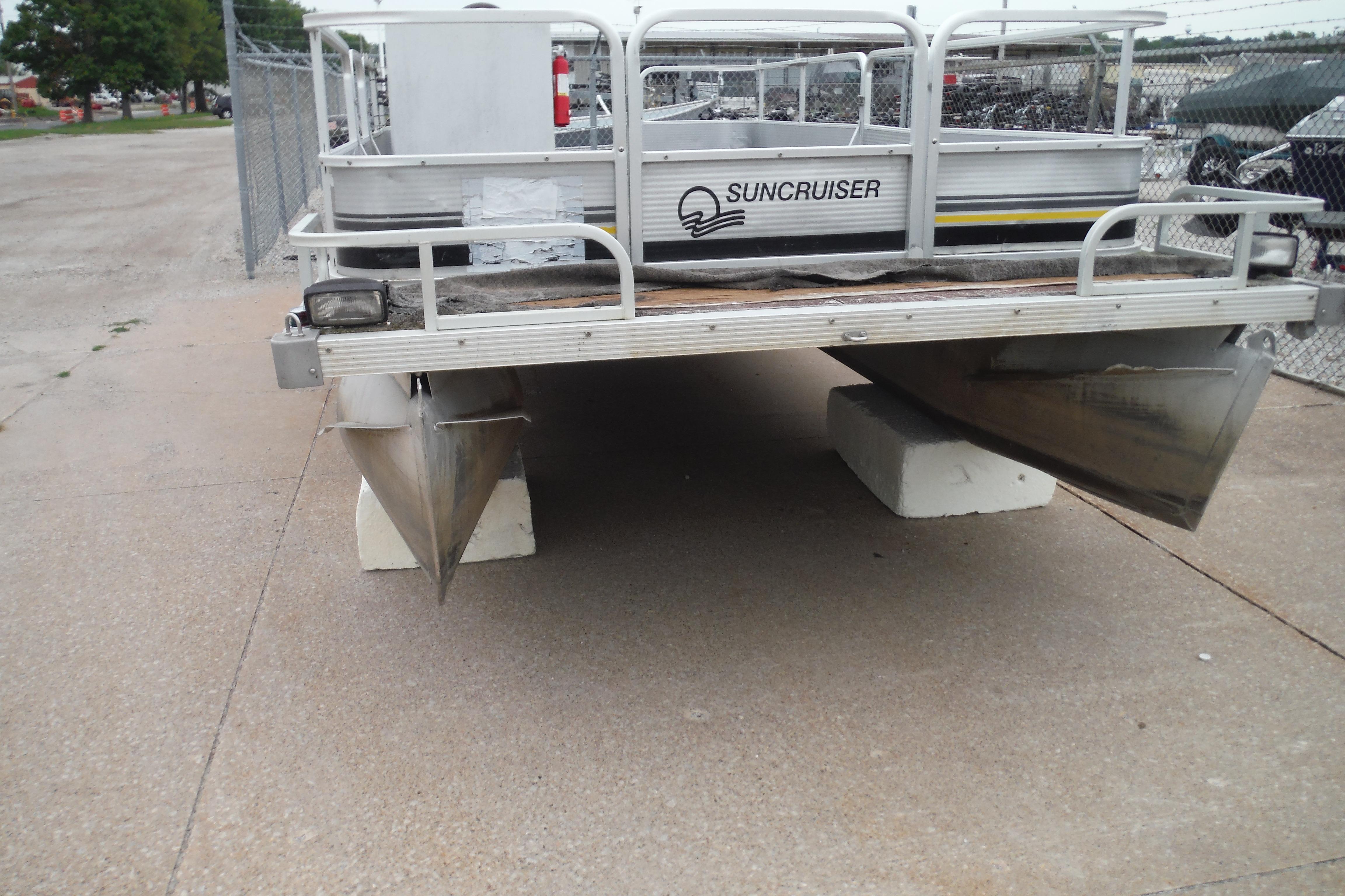 1989 Sea Nymph SS200 SUNCRUISER pontoon boat on concrete blocks in a parking area.