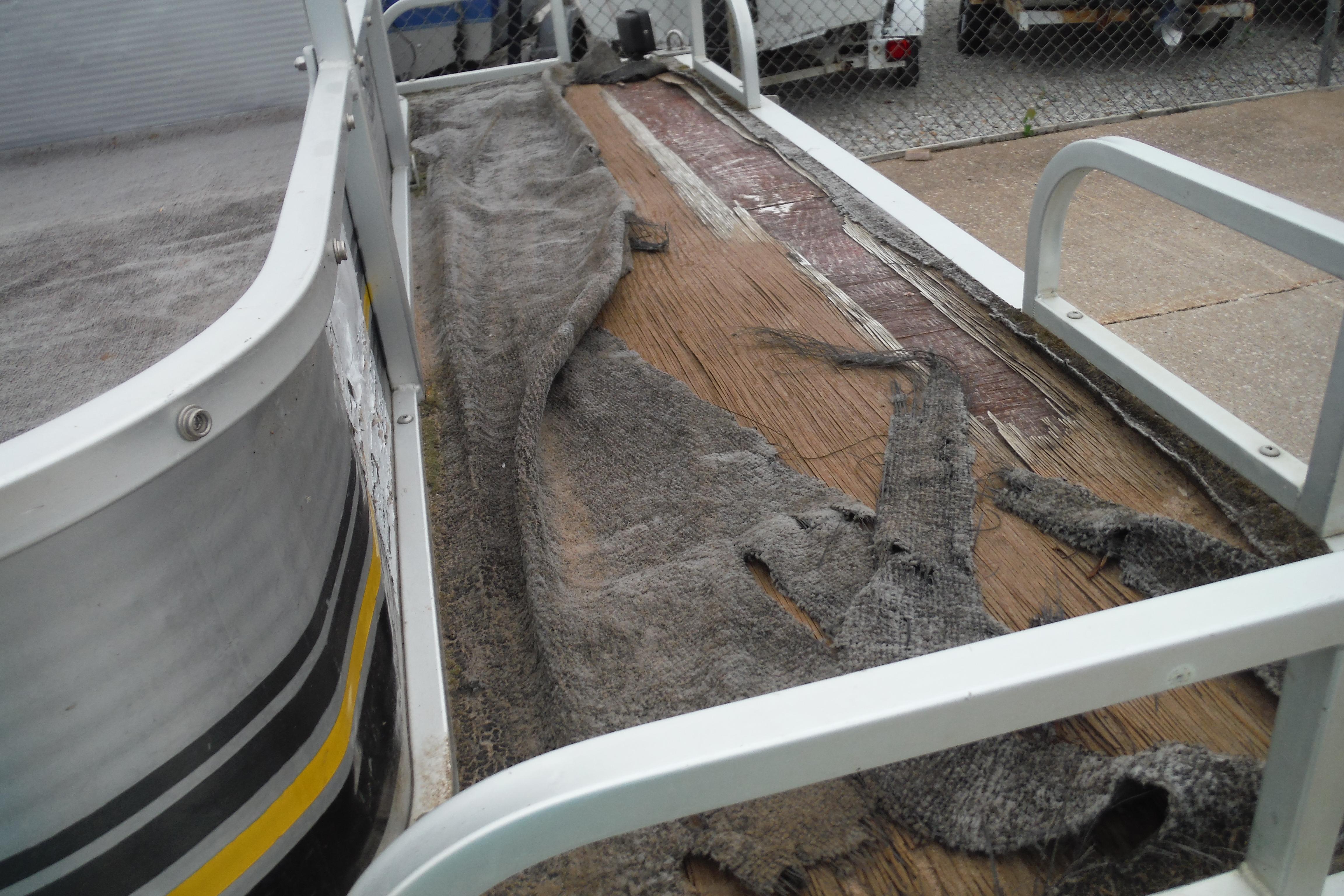 1989 Sea Nymph SS200 Suncruiser with worn flooring and peeling carpet.