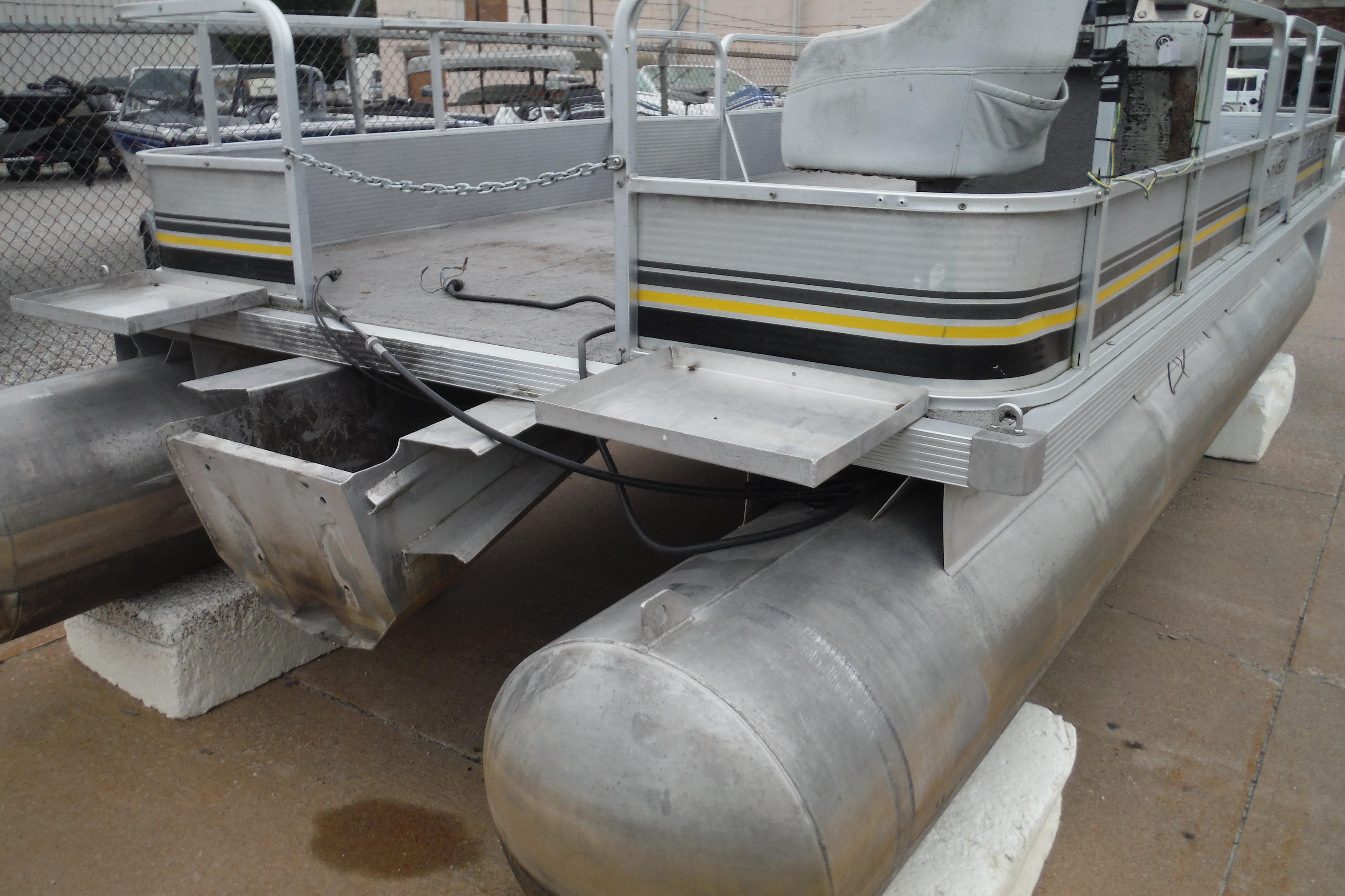 1989 Sea Nymph SS200 SUNCRUISER pontoon boat, docked on concrete blocks.