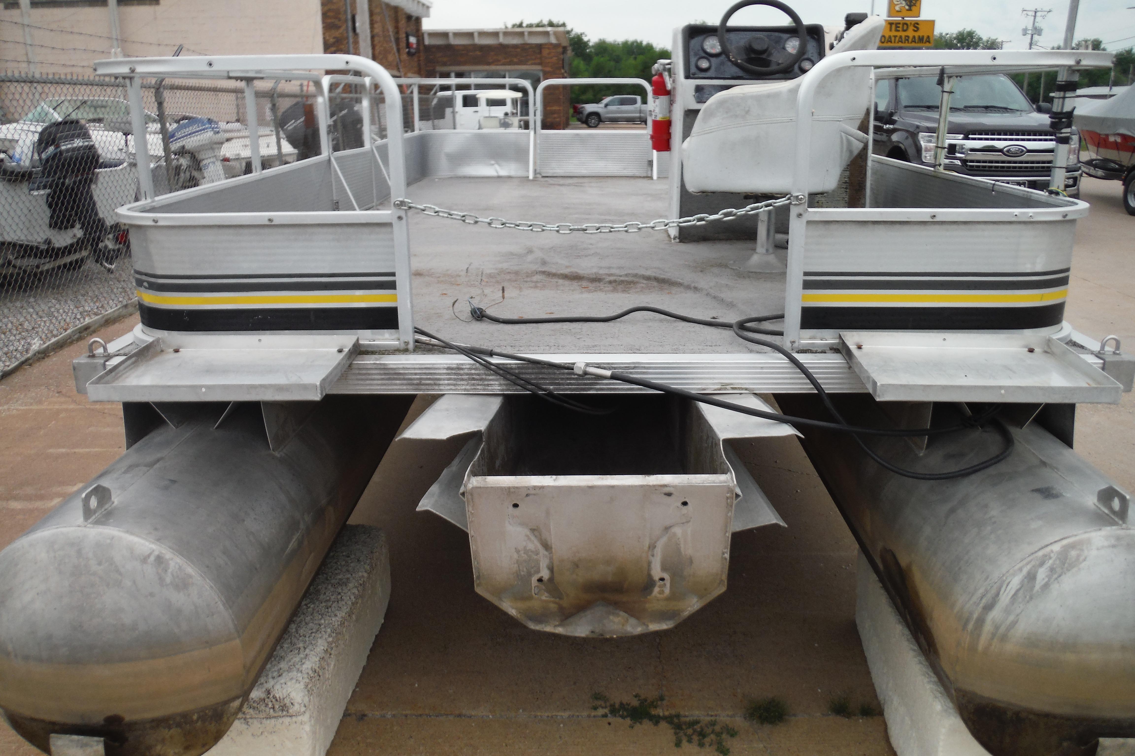 1989 Sea Nymph SS200 SUNCRUISER pontoon boat, docked, with visible steering console and pontoons.