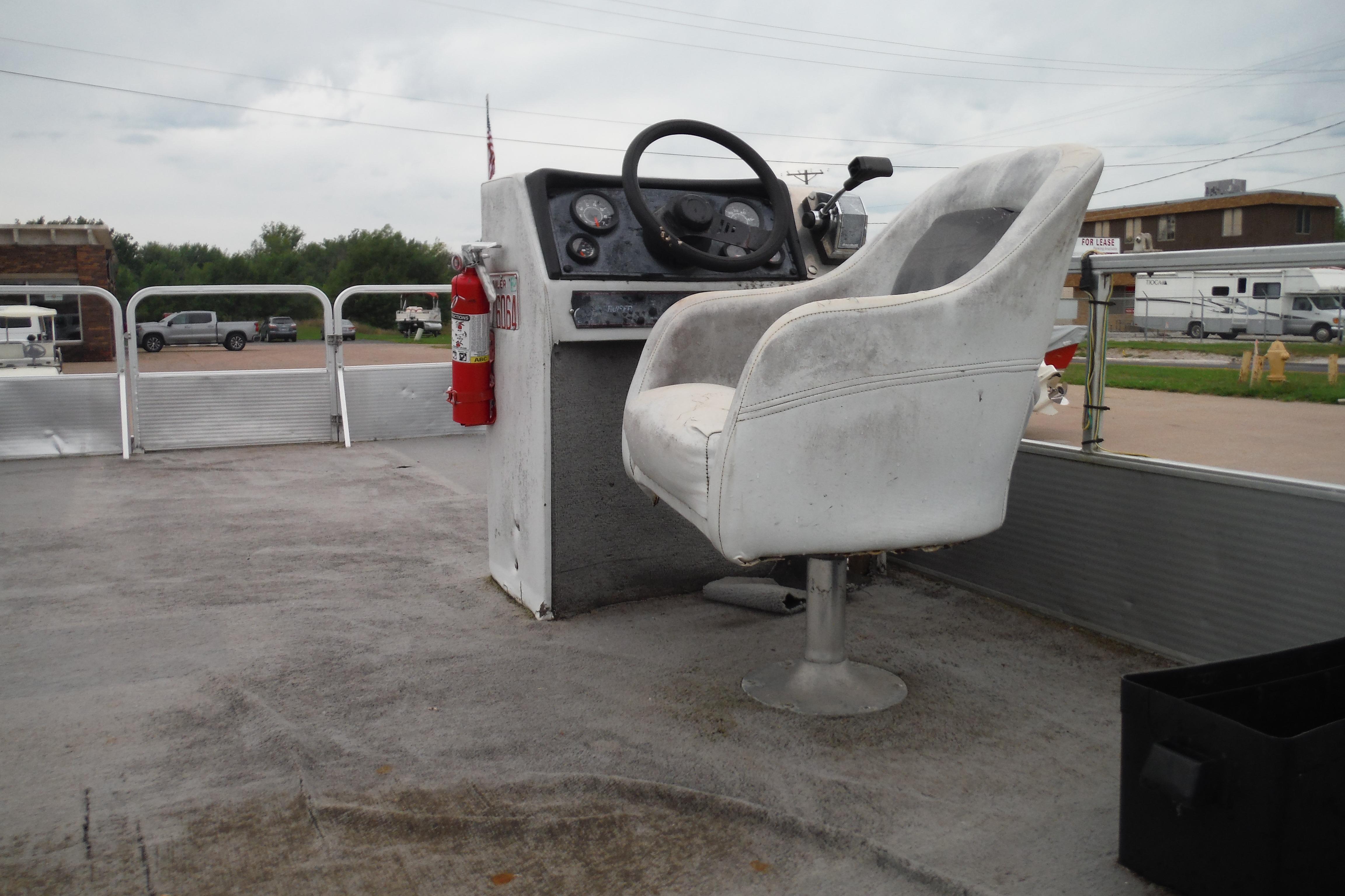 1989 Sea Nymph SS200 Suncruiser boat interior with steering console and captain's chair.