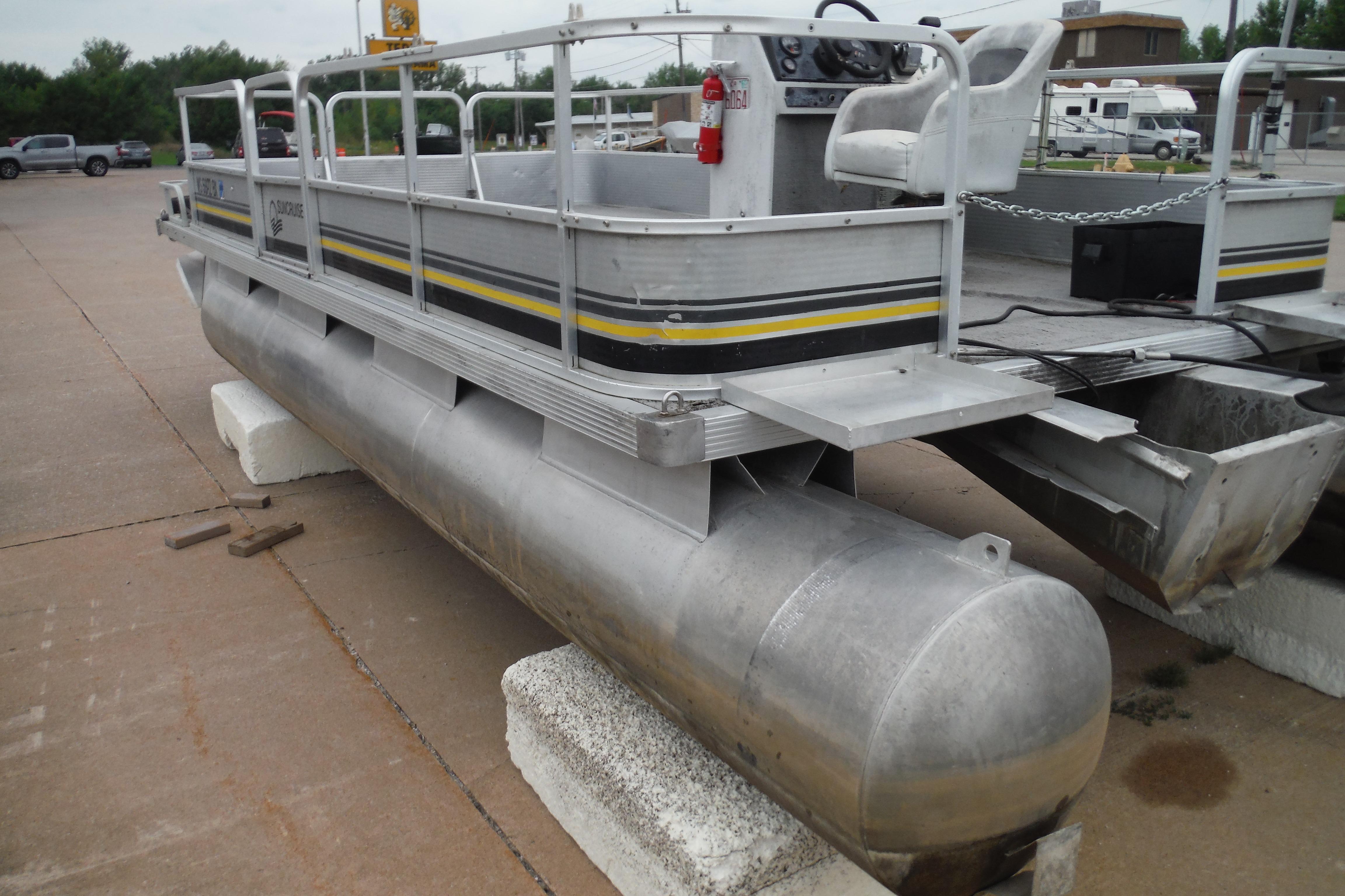 1989 Sea Nymph SS200 SUNCRUISER pontoon boat on concrete blocks in a parking lot.