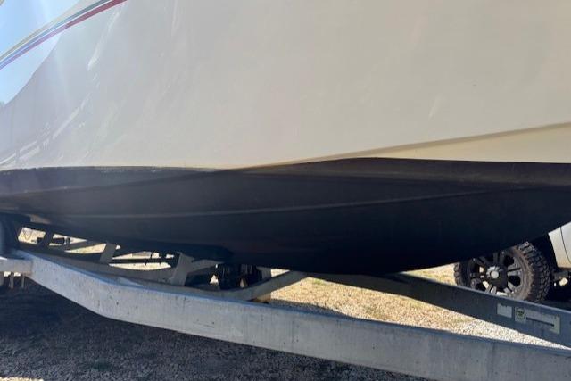 2000 Four Winns 238 Vista boat on trailer, side view.