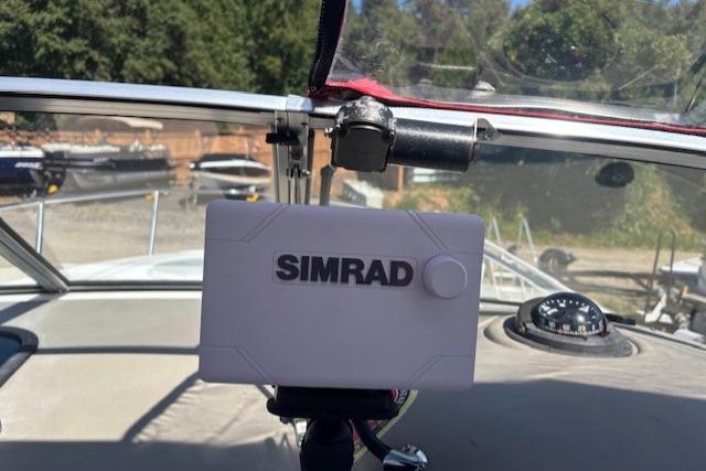 Simrad navigation system on 2000 Four Winns 238 Vista boat dashboard.