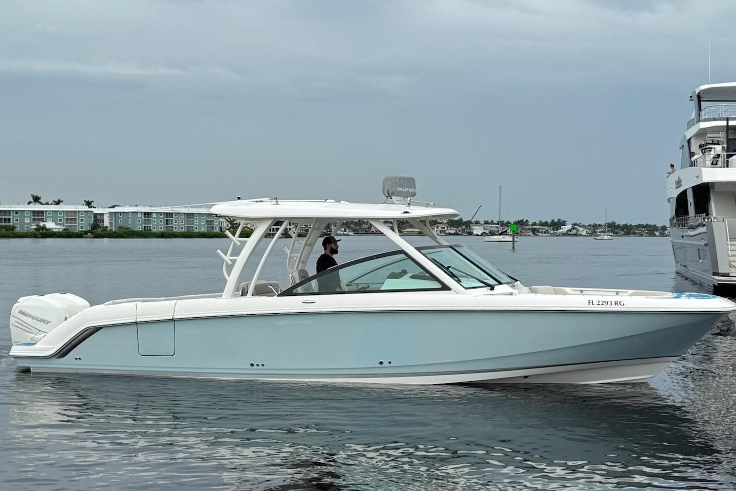 2017 Boston Whaler 320 Vantage boat on calm water, side view.