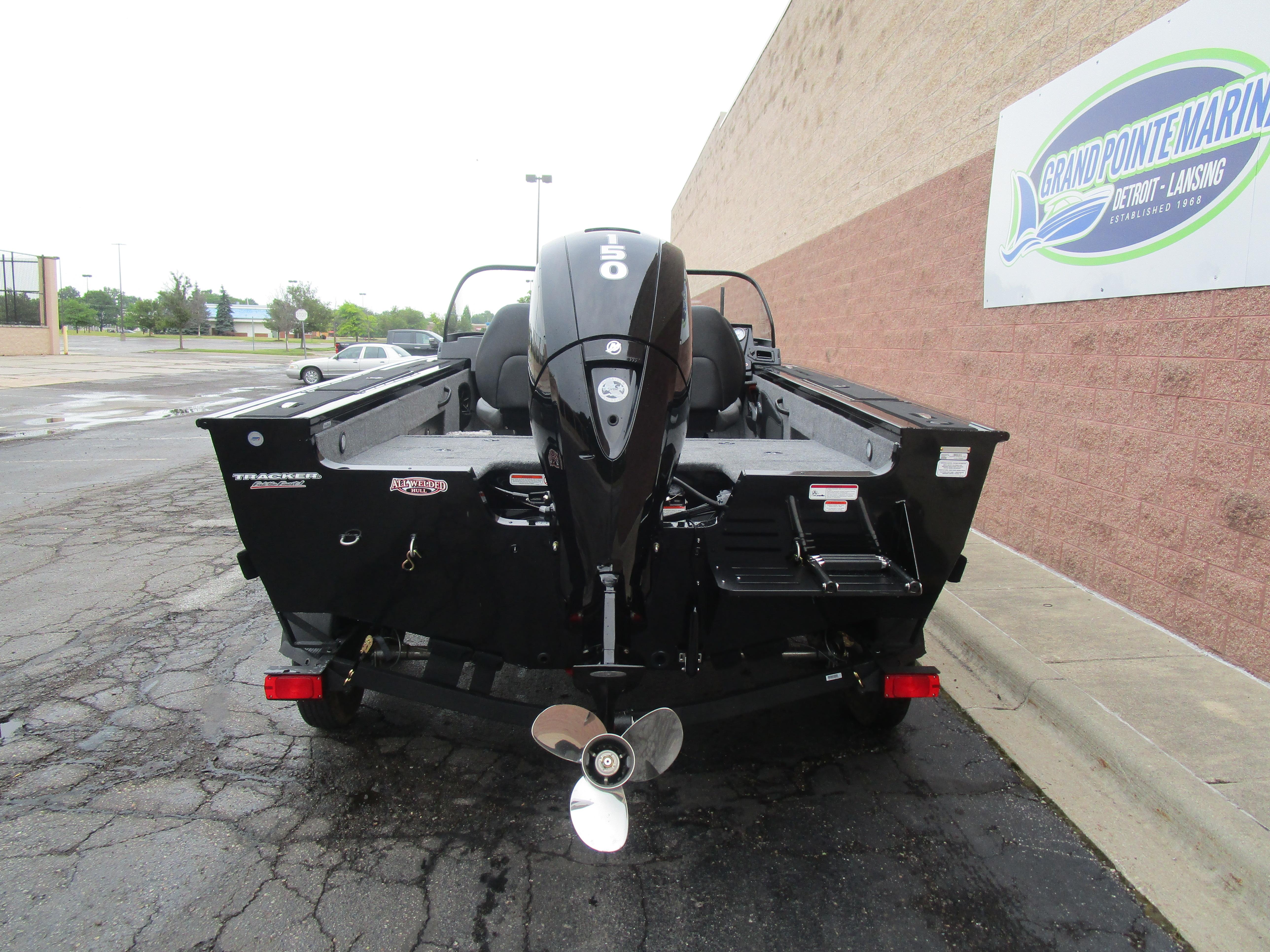 2026 Tracker Targa 18 WT boat with outboard motor, parked at Grand Pointe Marina.