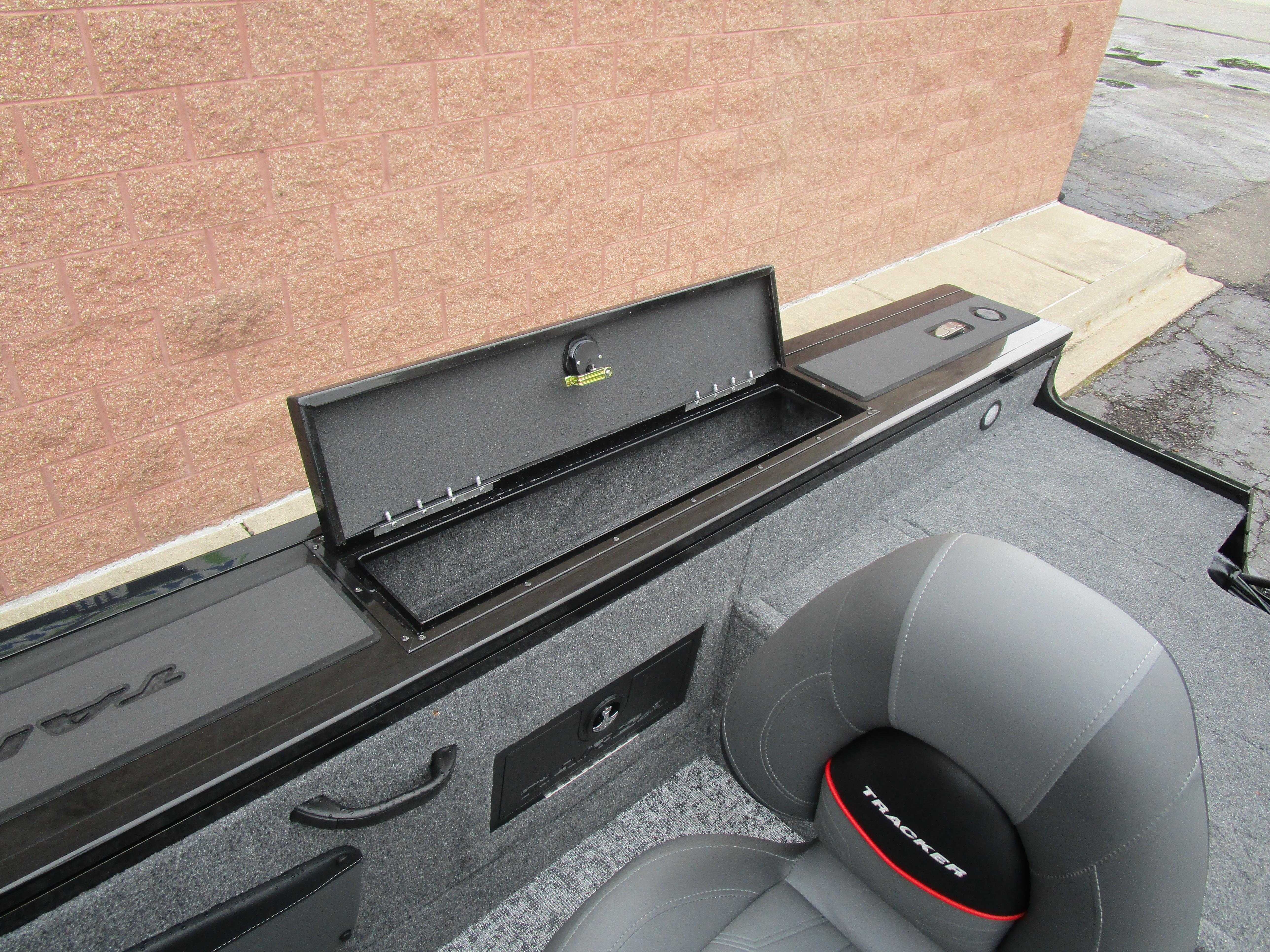 2026 Tracker Targa 18 WT boat interior with open storage compartment and gray seating.