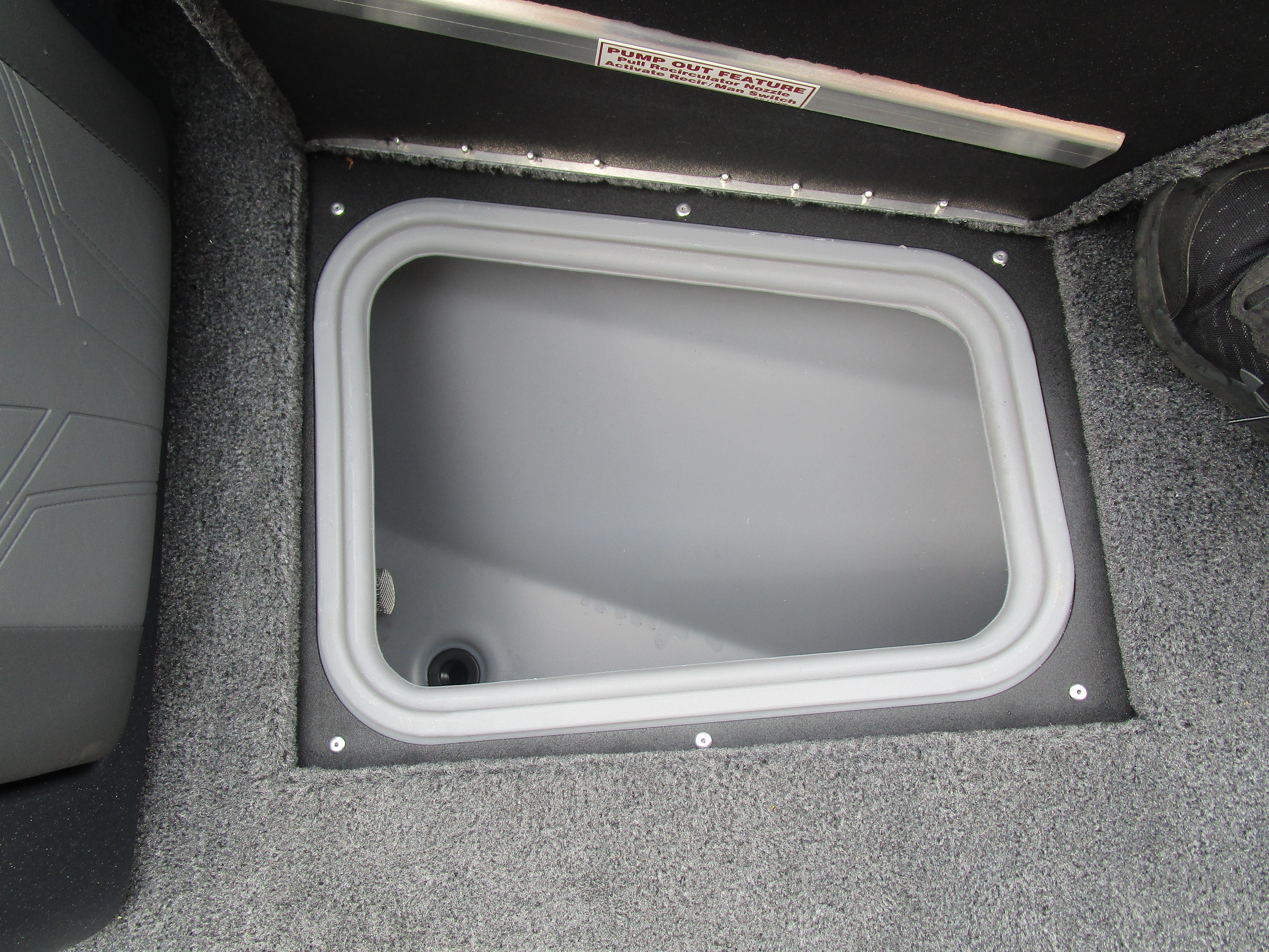 2026 Tracker Targa 18 WT boat storage compartment with gray interior.