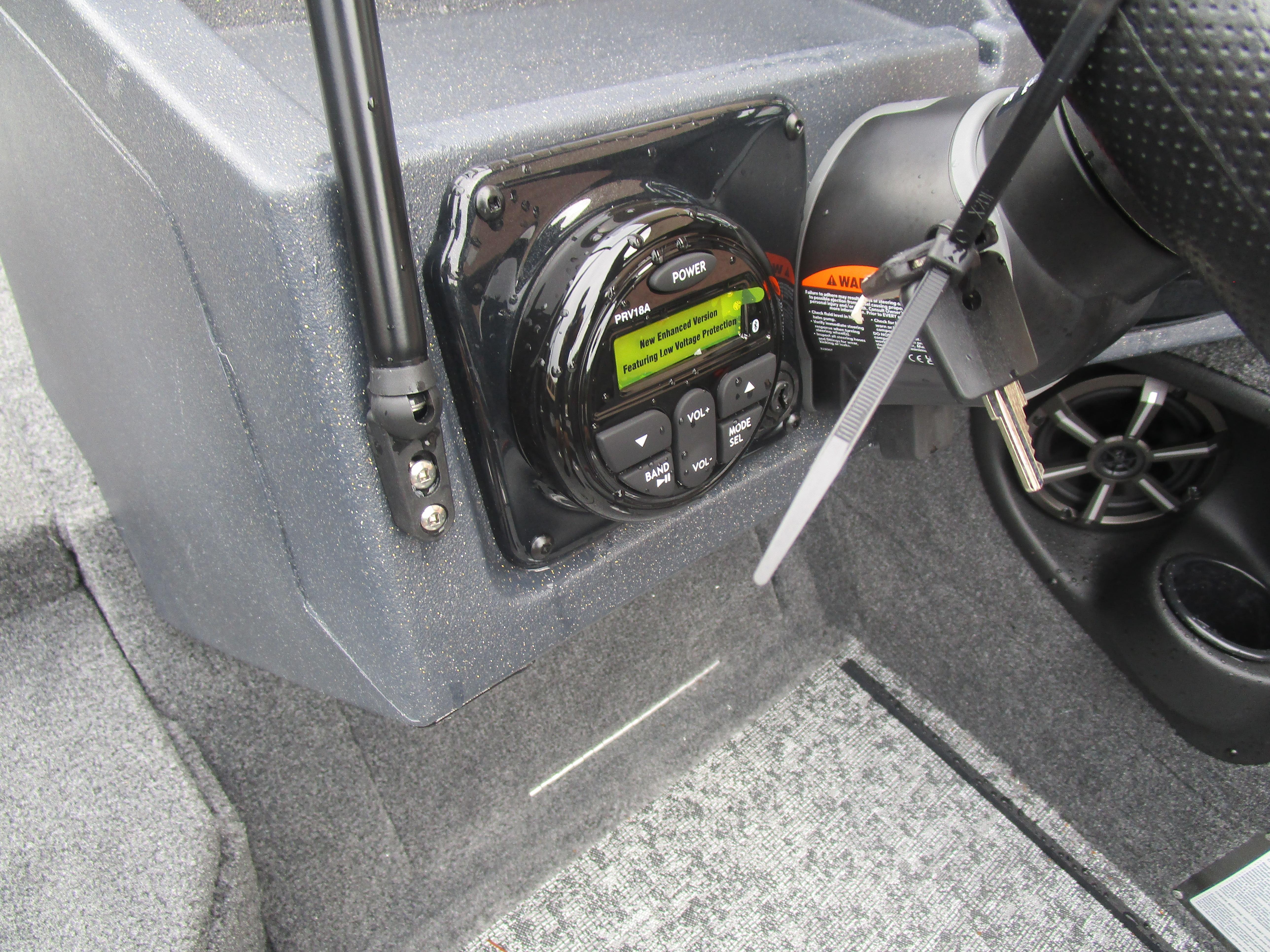 Control panel of 2026 Tracker Targa 18 WT boat with steering wheel and audio system.