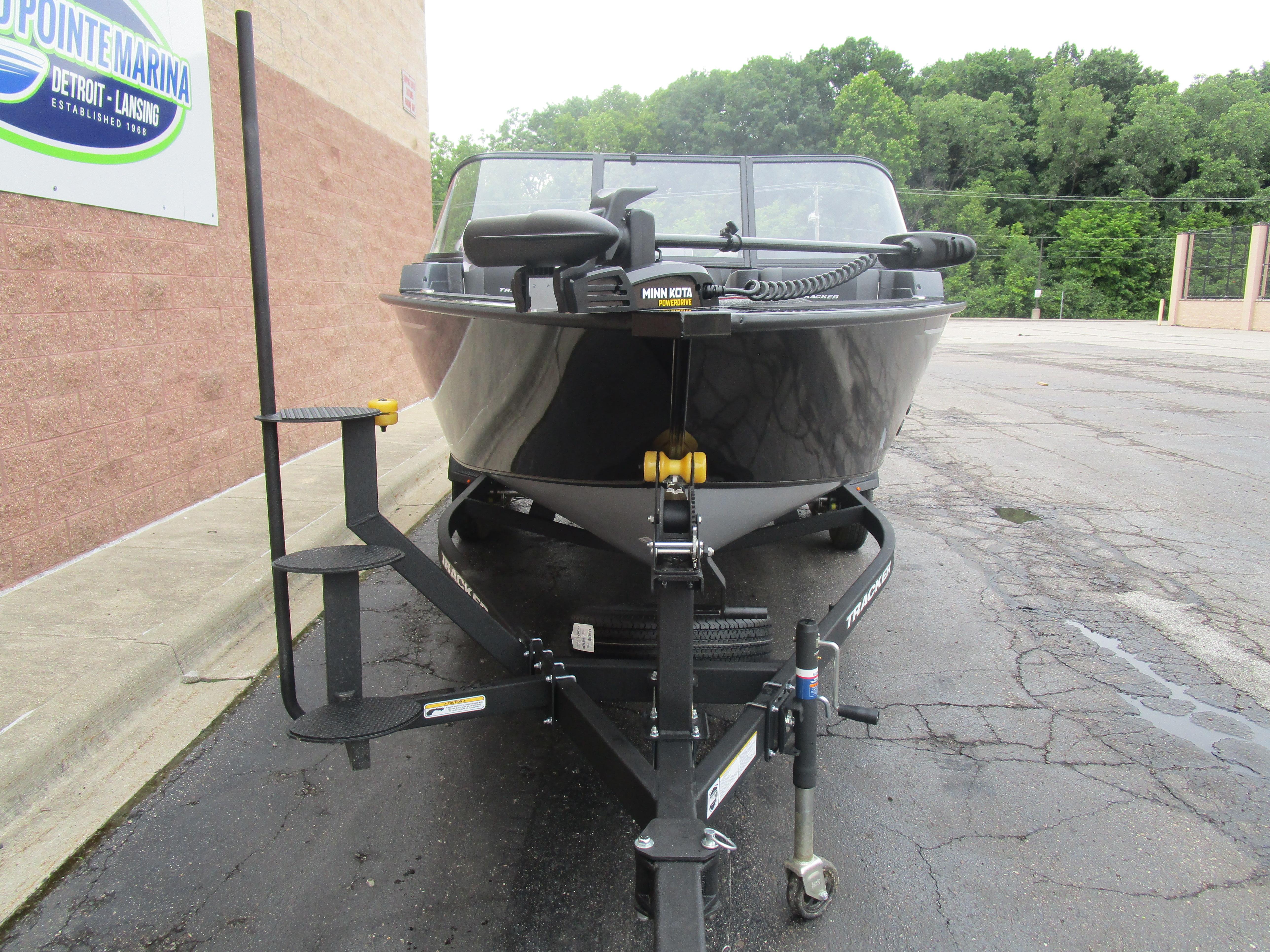 2026 Tracker Targa 18 WT boat on trailer at marina parking lot.