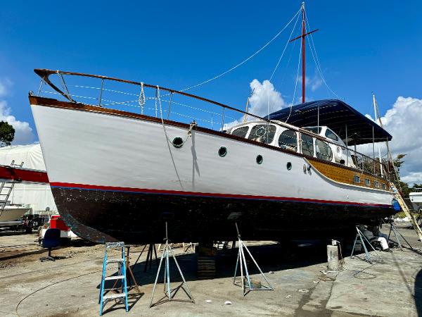1966 Rampart 48 yacht on dry dock, showcasing classic design and elegant wooden details.