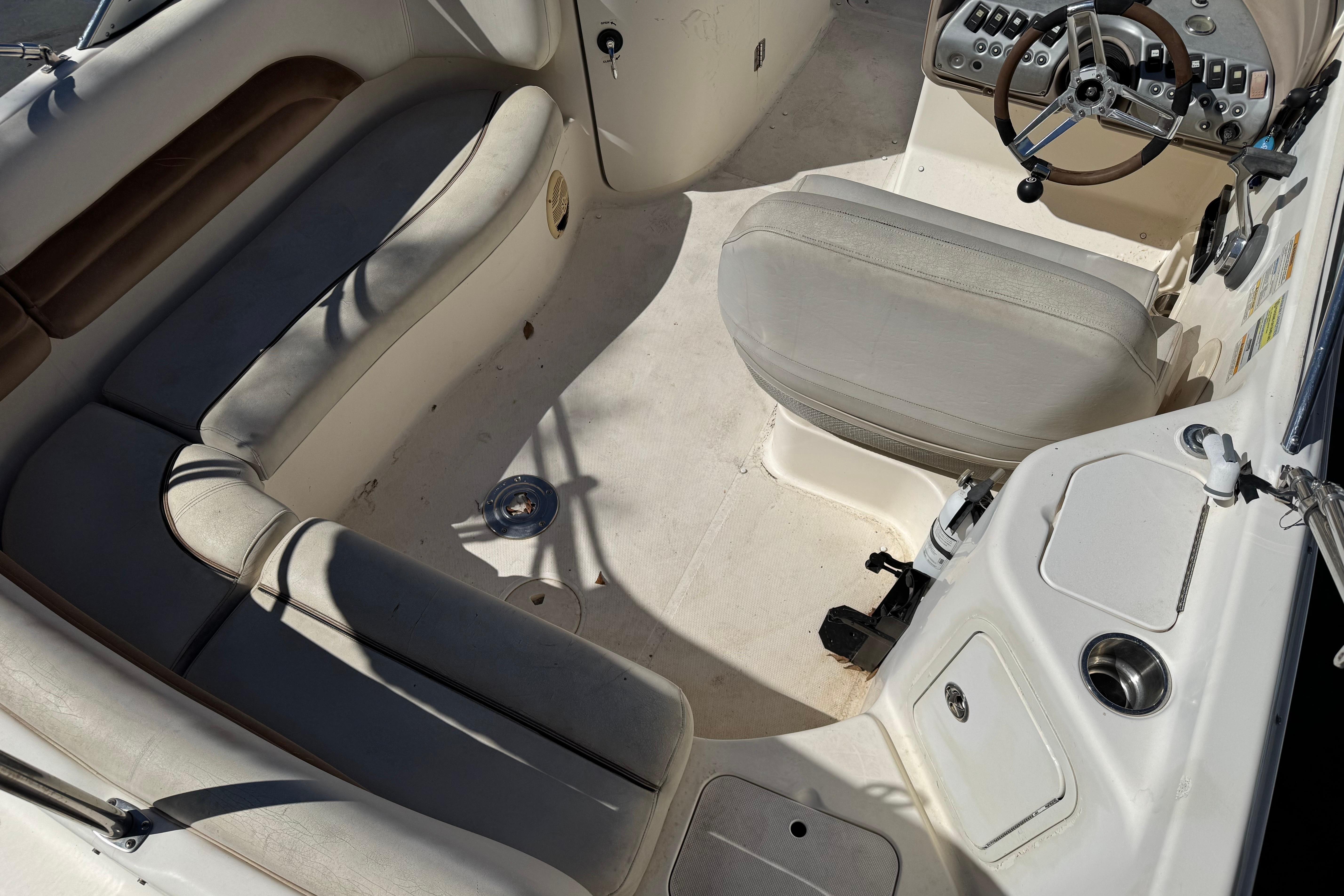 2007 Hurricane SunDeck 217 OB boat interior with seating and steering console.