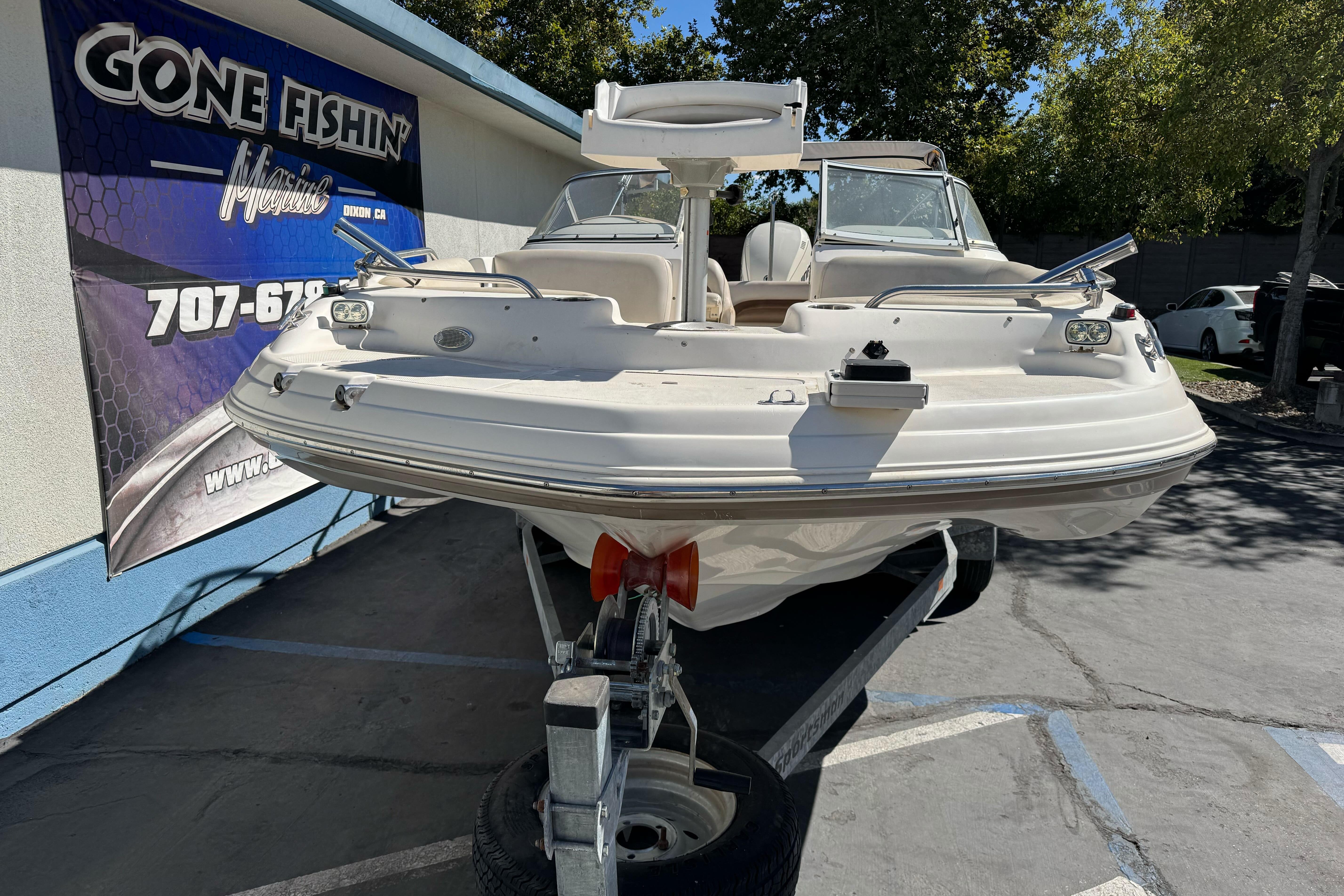 2007 Hurricane SunDeck 217 OB boat on trailer at Gone Fishin' Marine dealership.