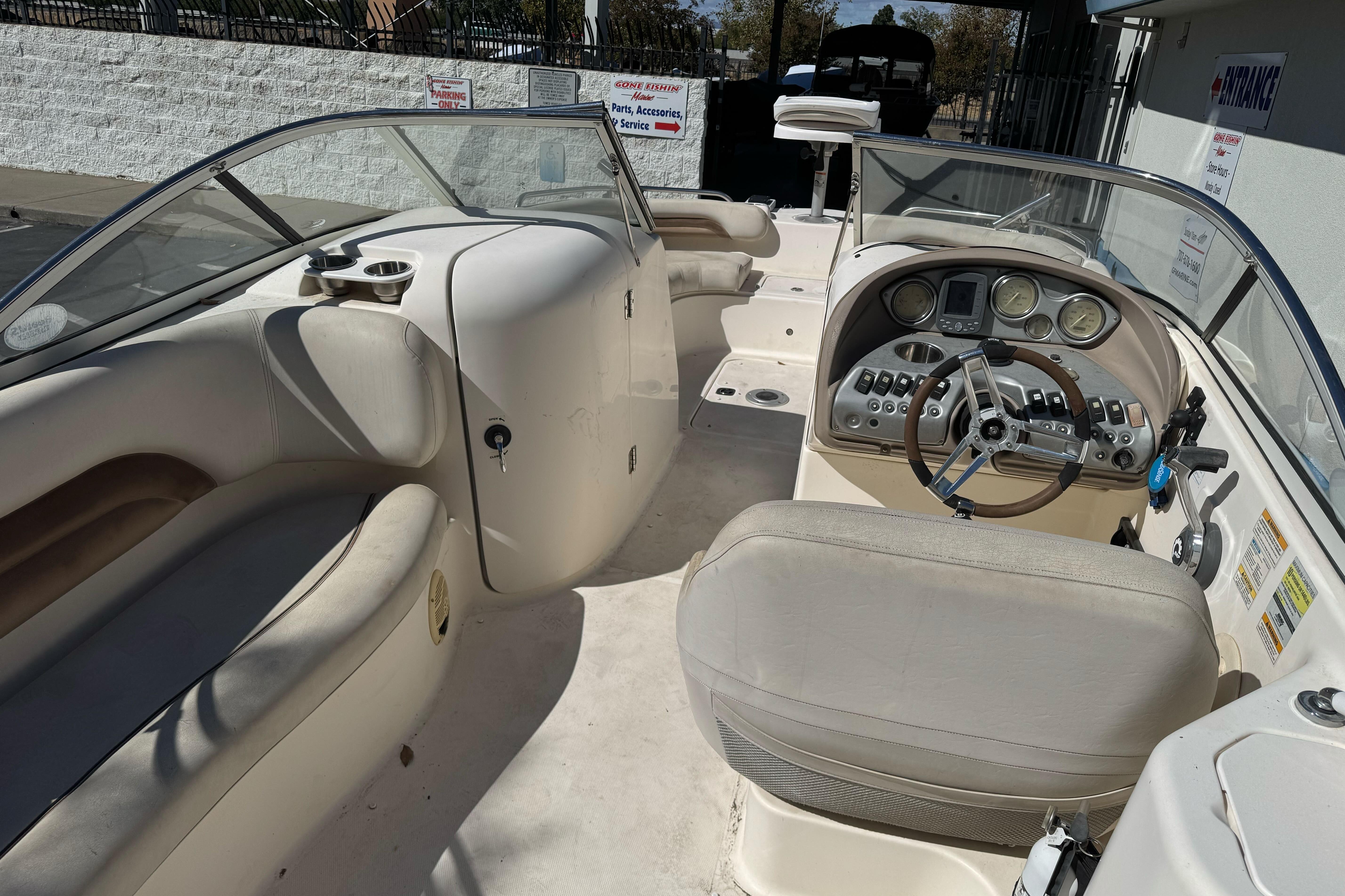 2007 Hurricane SunDeck 217 OB boat interior with steering wheel and seating area.