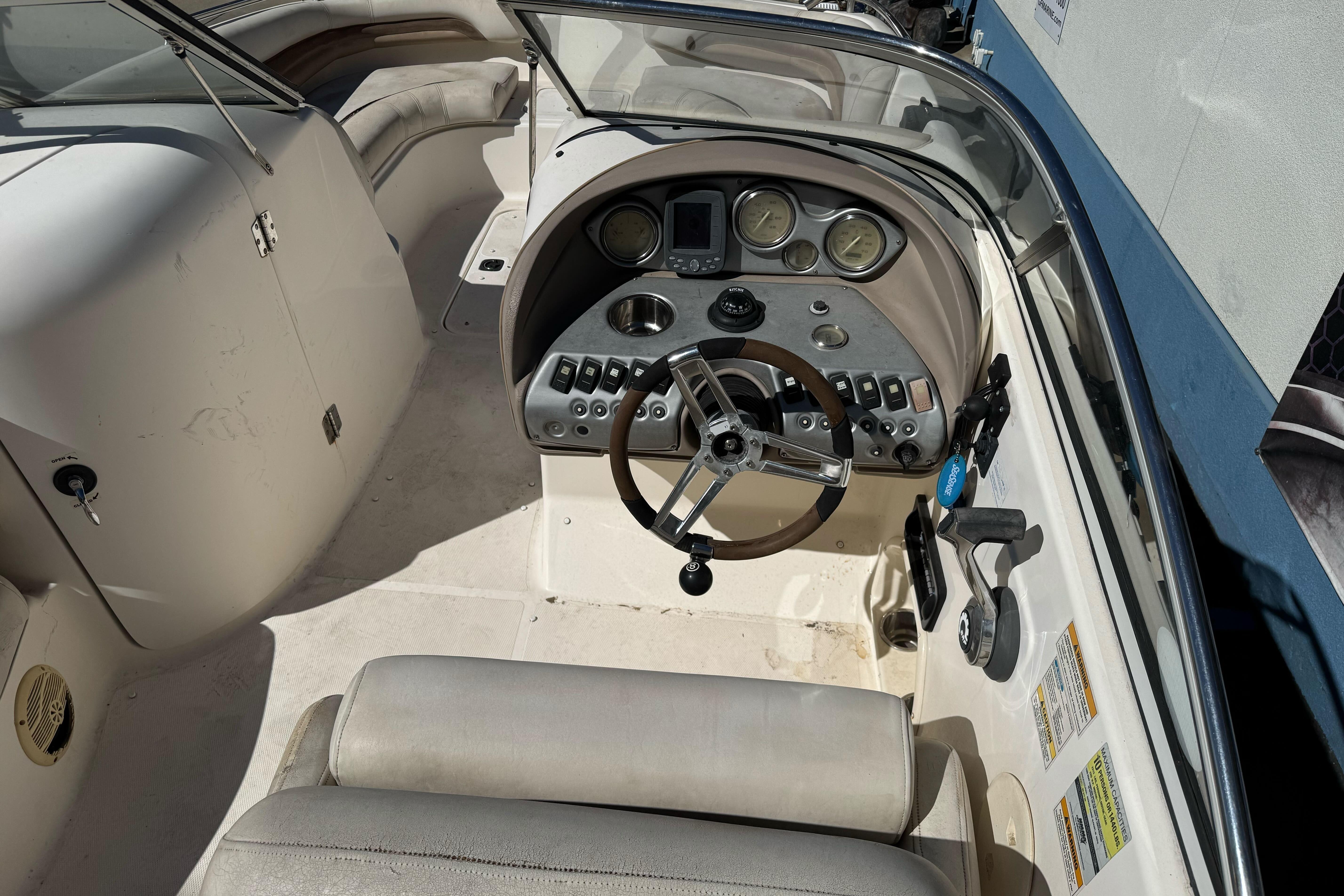 2007 Hurricane SunDeck 217 OB boat cockpit with steering wheel and control panel.
