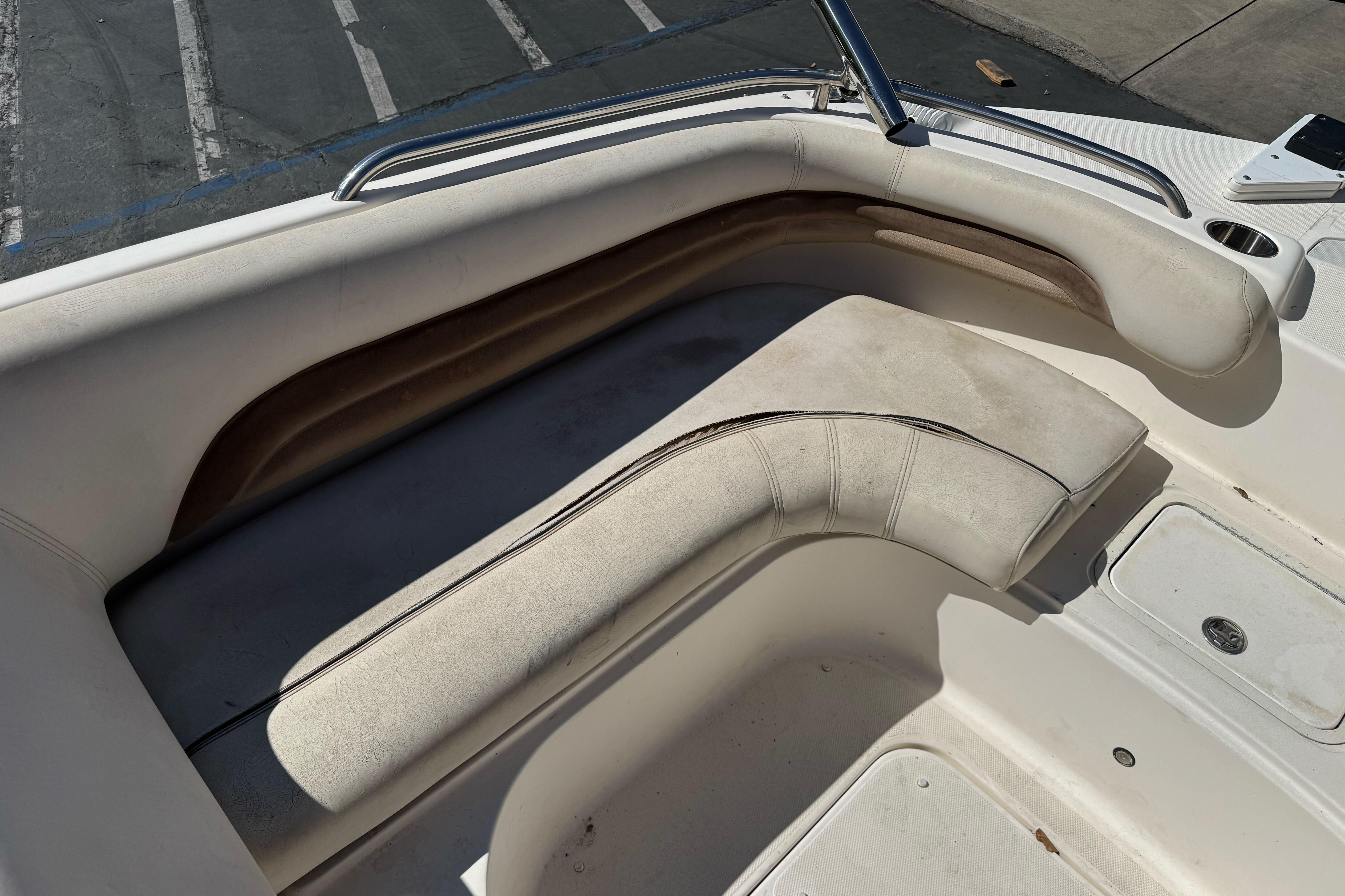 2007 Hurricane SunDeck 217 OB boat interior with white cushioned seating.