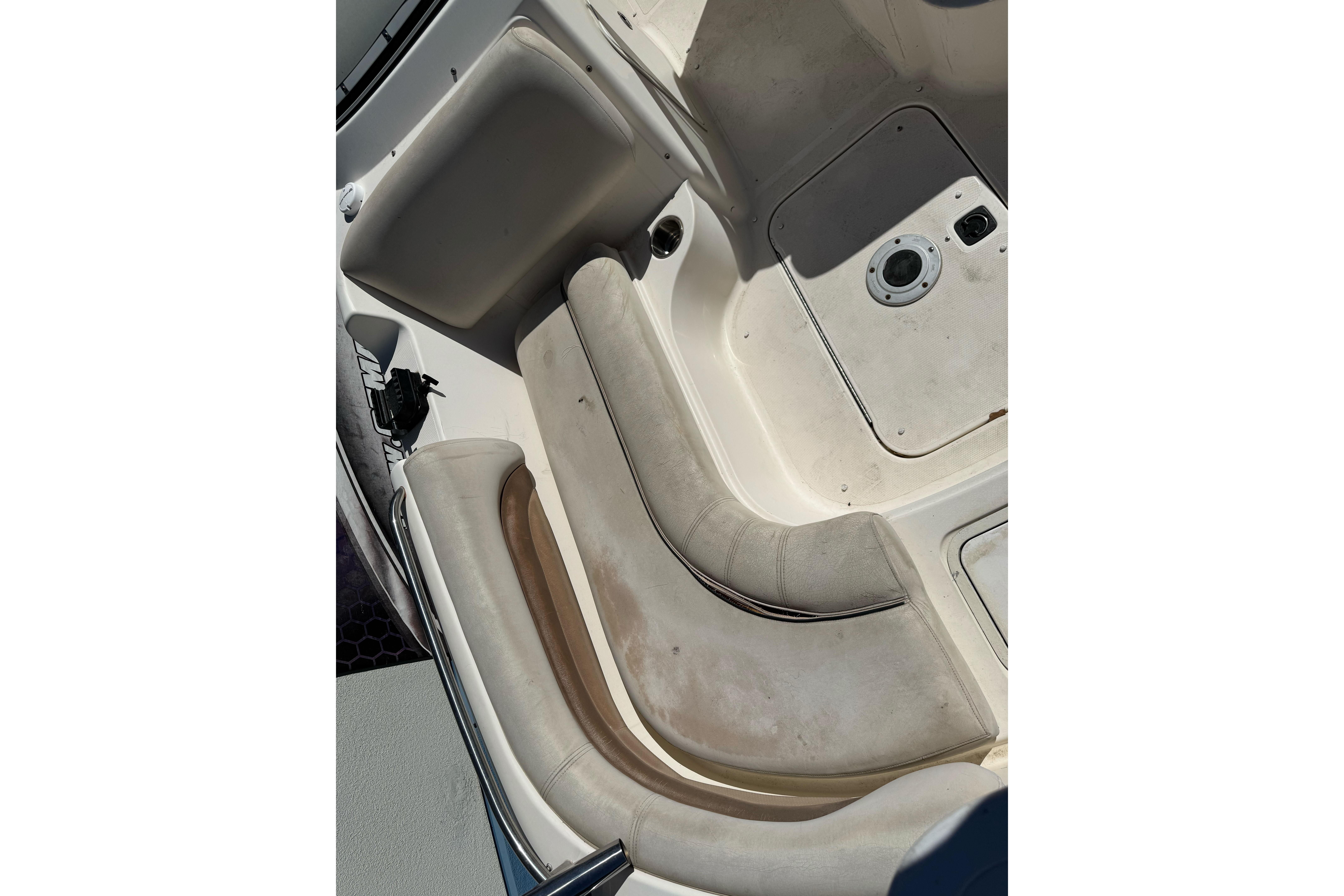 2007 Hurricane SunDeck 217 OB boat interior with white seating and storage compartments.