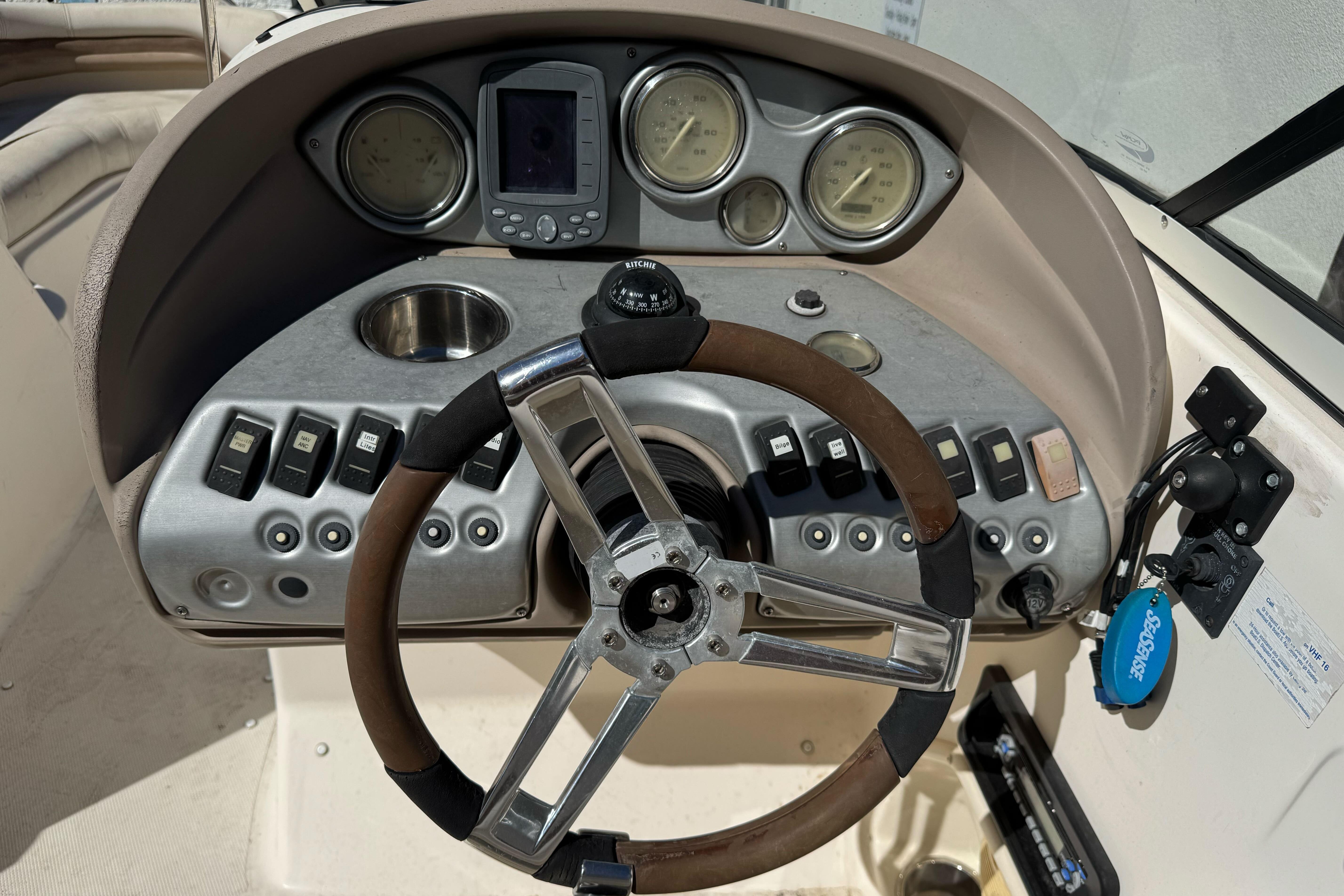 2007 Hurricane SunDeck 217 OB boat dashboard with steering wheel and control panel.