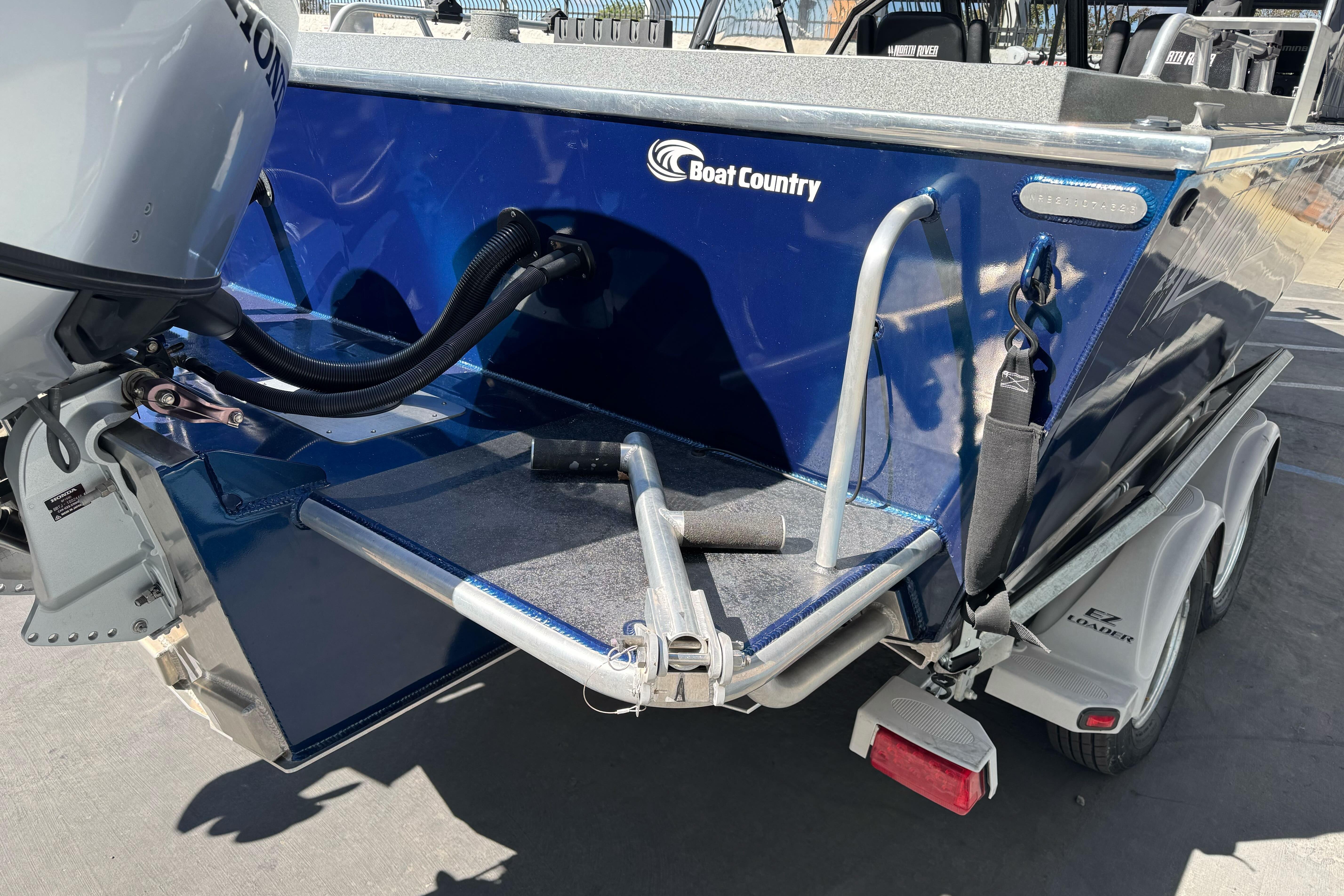 2023 North River 21 X 84 Seahawk boat on trailer, featuring outboard motor.