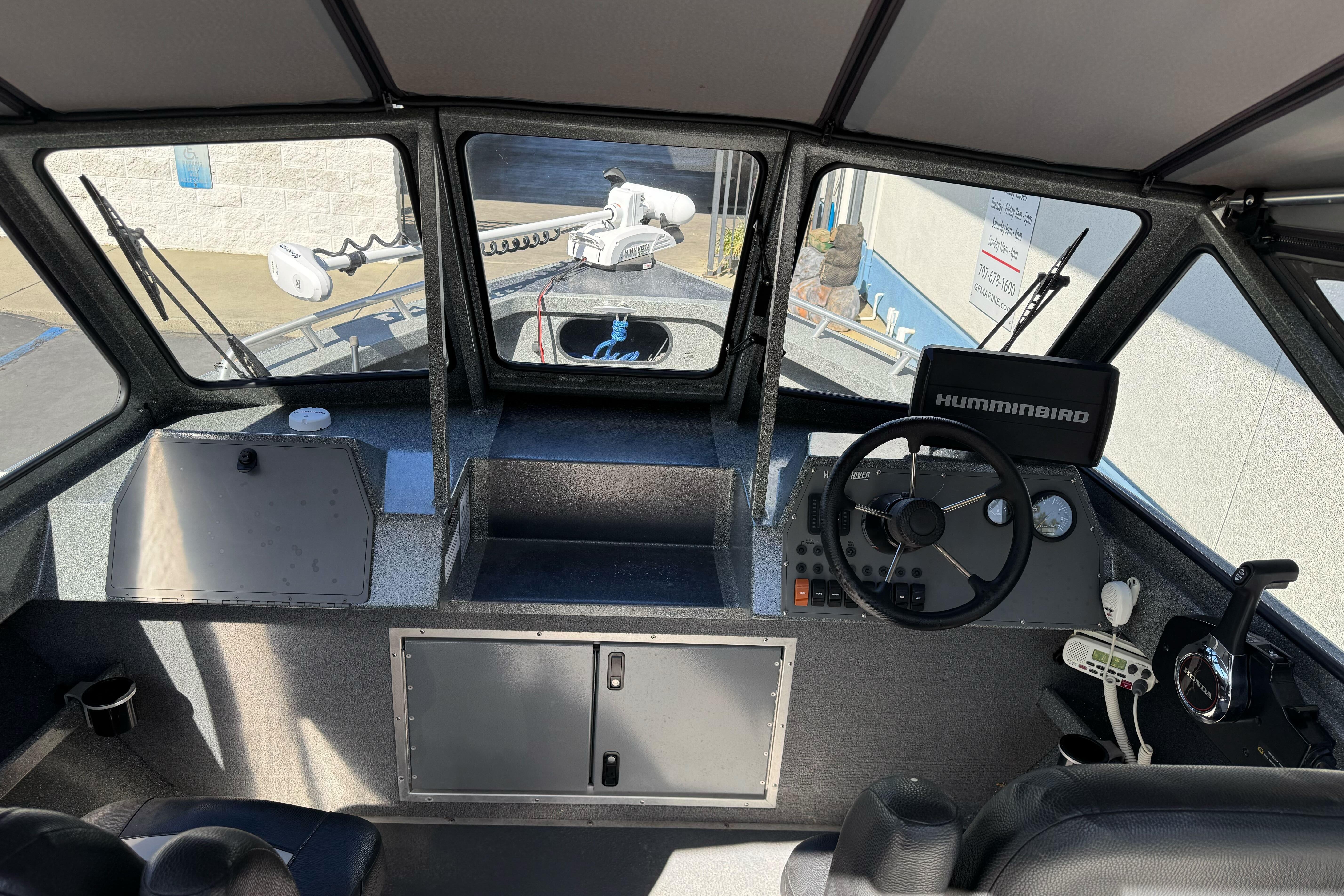 Interior view of 2023 North River 21 X 84 Seahawk boat cockpit with steering wheel and controls.