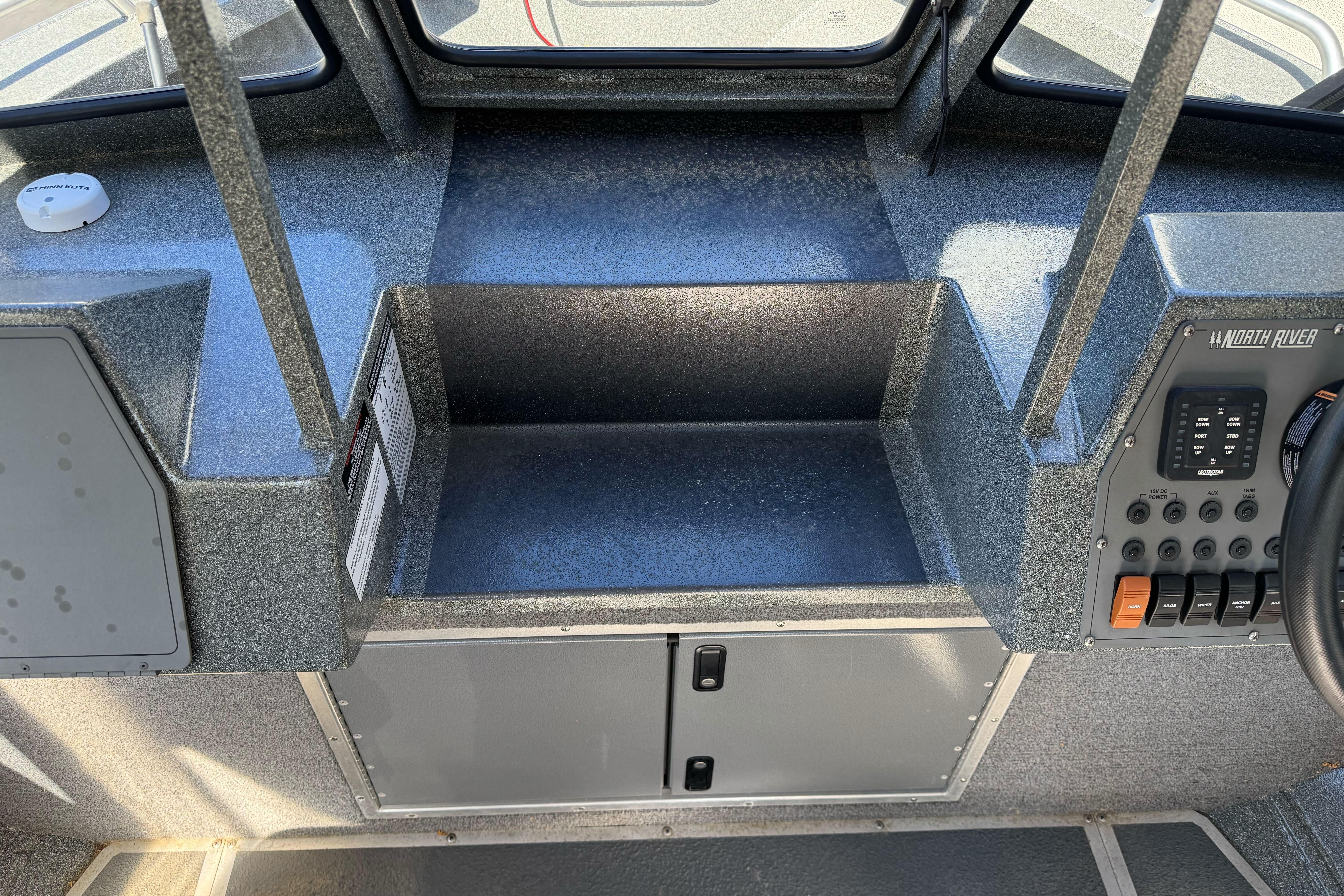 2023 North River 21 X 84 Seahawk boat dashboard with control panel and storage.