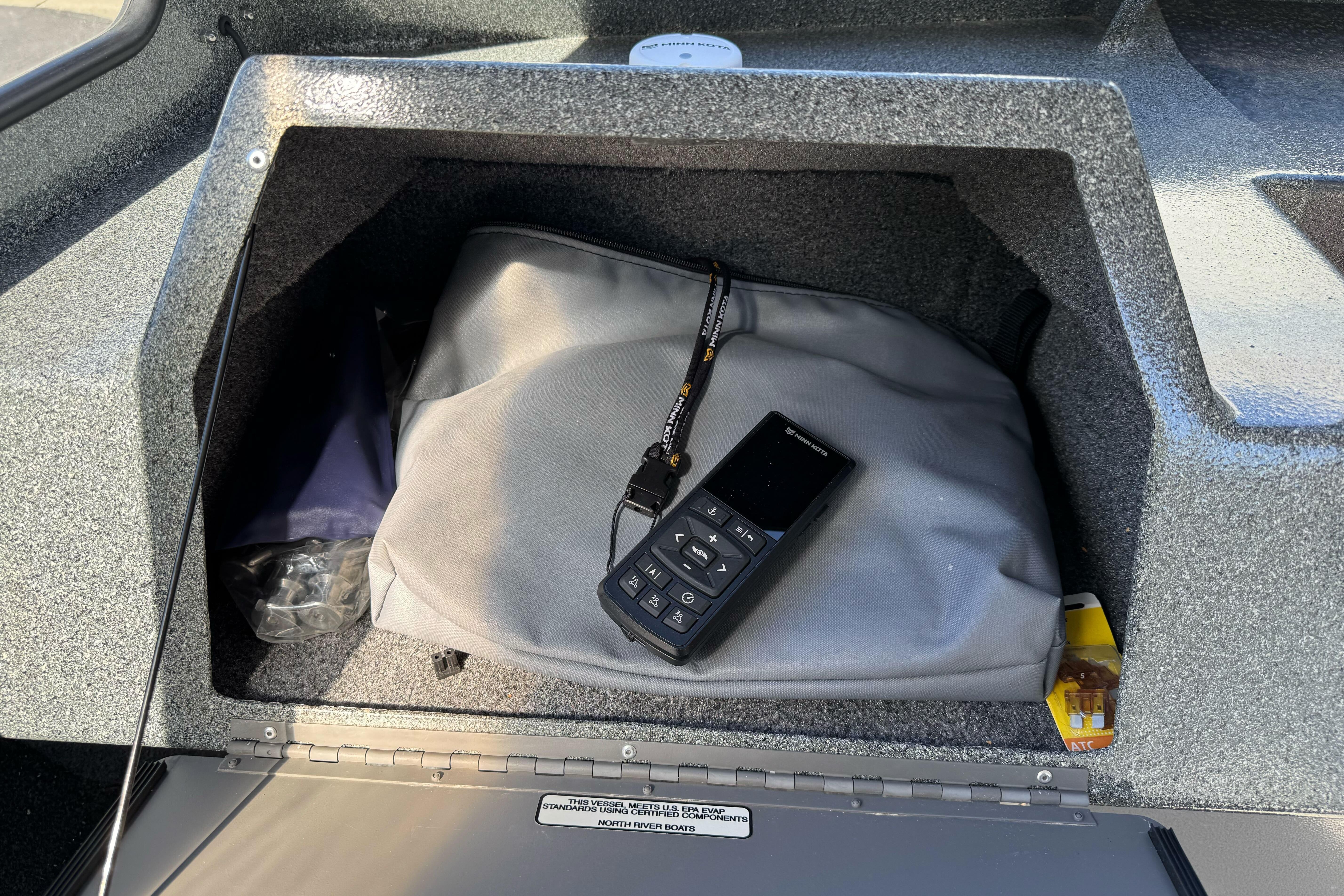Storage compartment in 2023 North River 21 X 84 Seahawk boat with bag and device.
