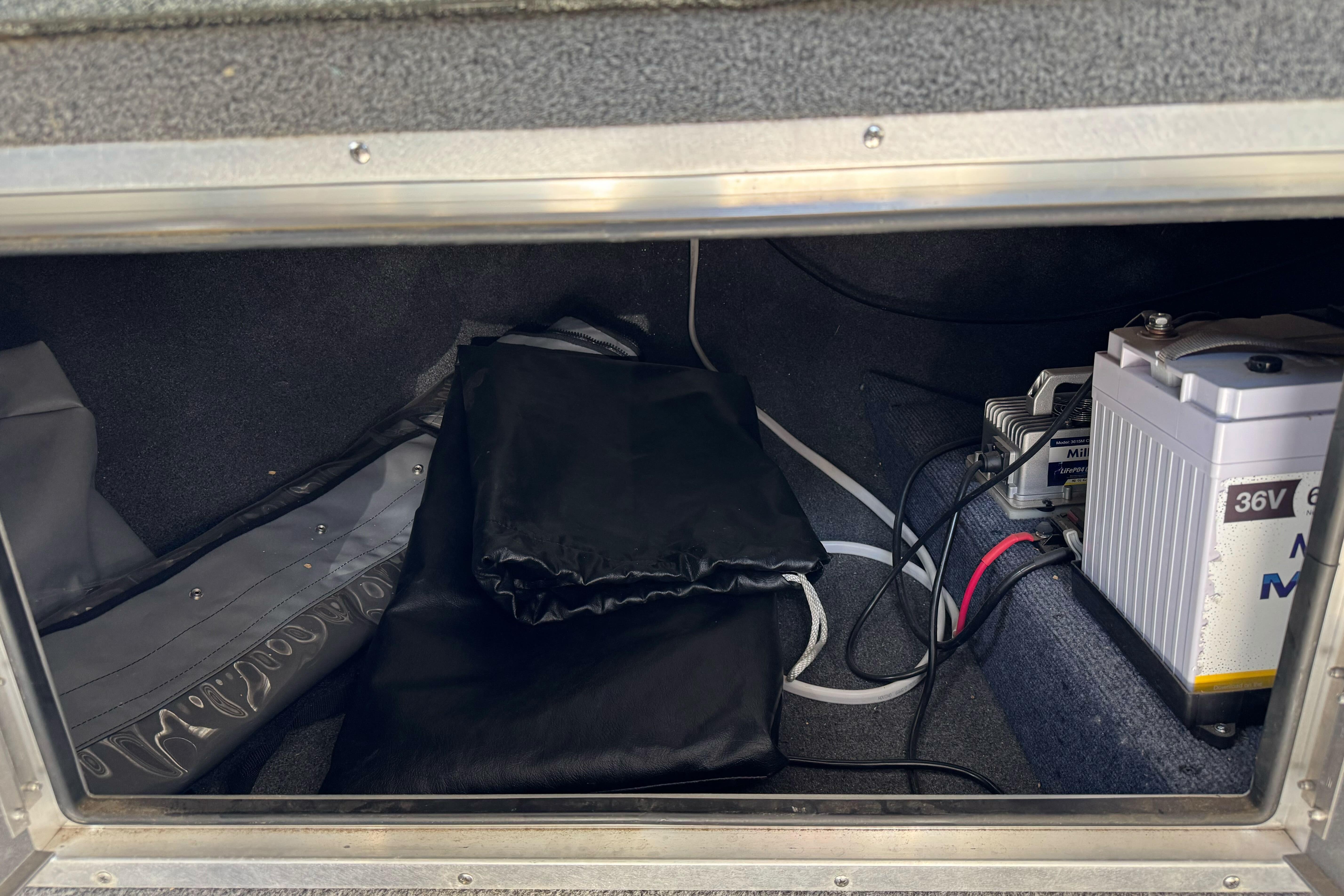 Storage compartment of 2023 North River 21 X 84 Seahawk with battery and equipment.