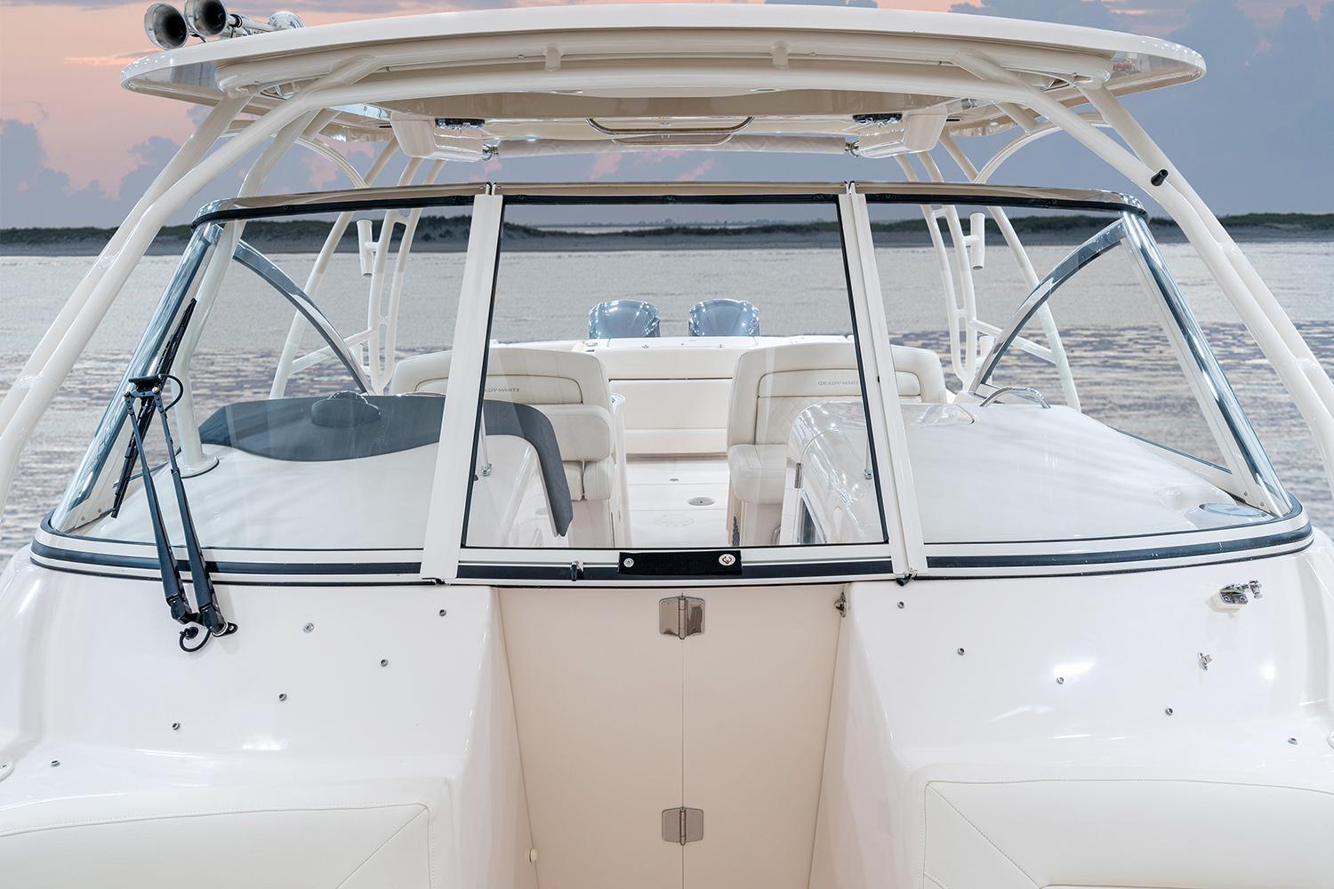 Manufacturer Provided Image: 2023 Grady-White Freedom 307 boat with open cockpit and seating, docked on calm water.