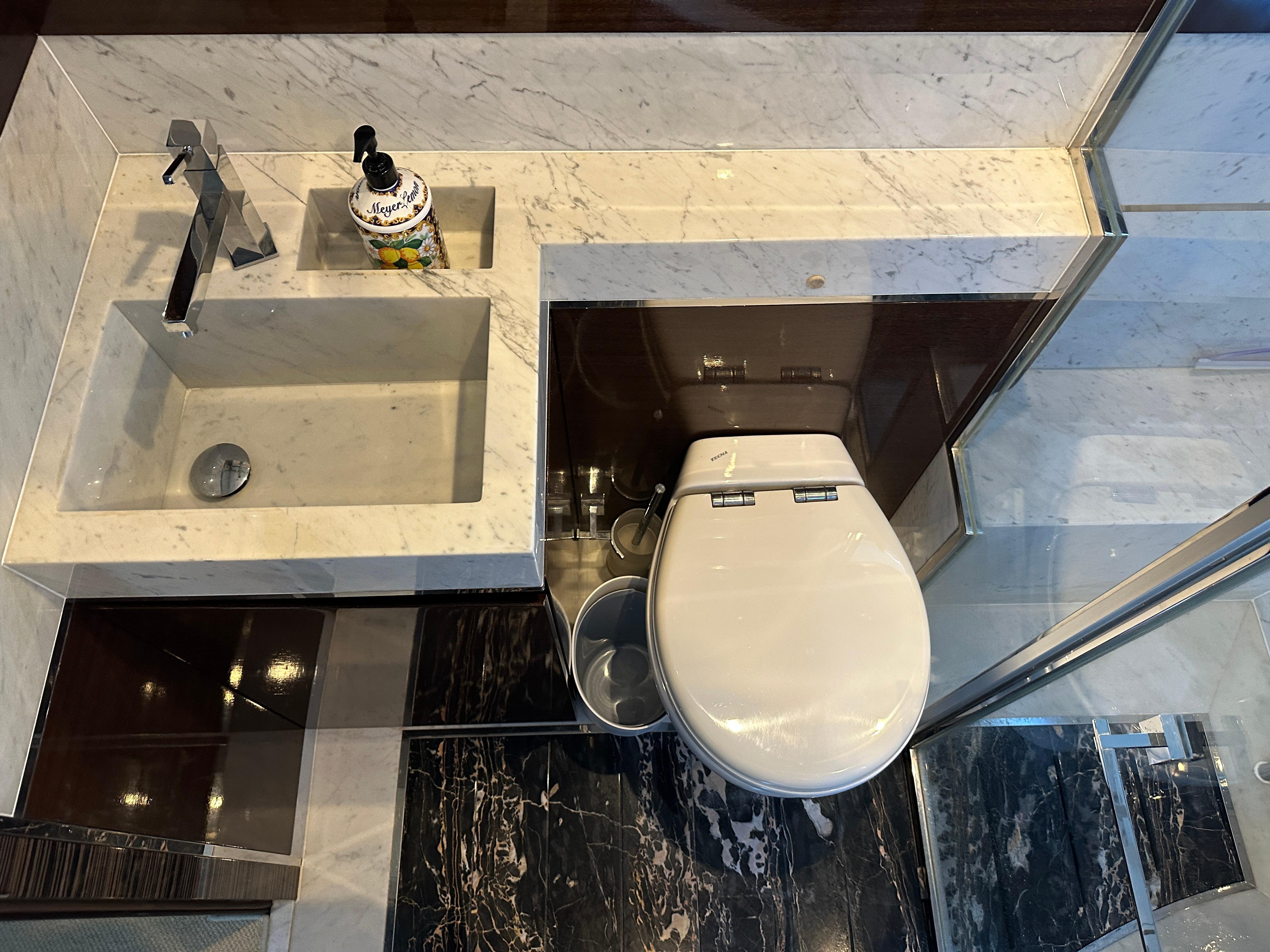 Cheoy Lee-Alpha 87 Express Sportbridge 2014-BBELLA FL-US-Luxurious bathroom in 2014 Cheoy Lee Alpha 87 Express Sportbridge yacht with marble sink and modern toilet.-9807207 | Thumbnail
