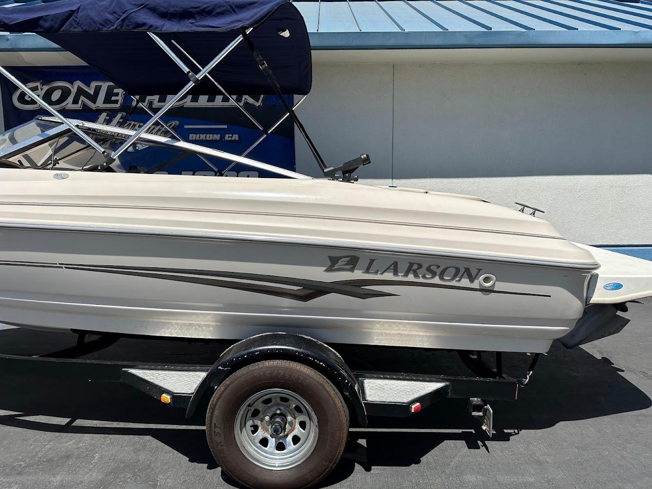 2001 Larson SEi 190 boat on trailer, side view, with blue canopy.