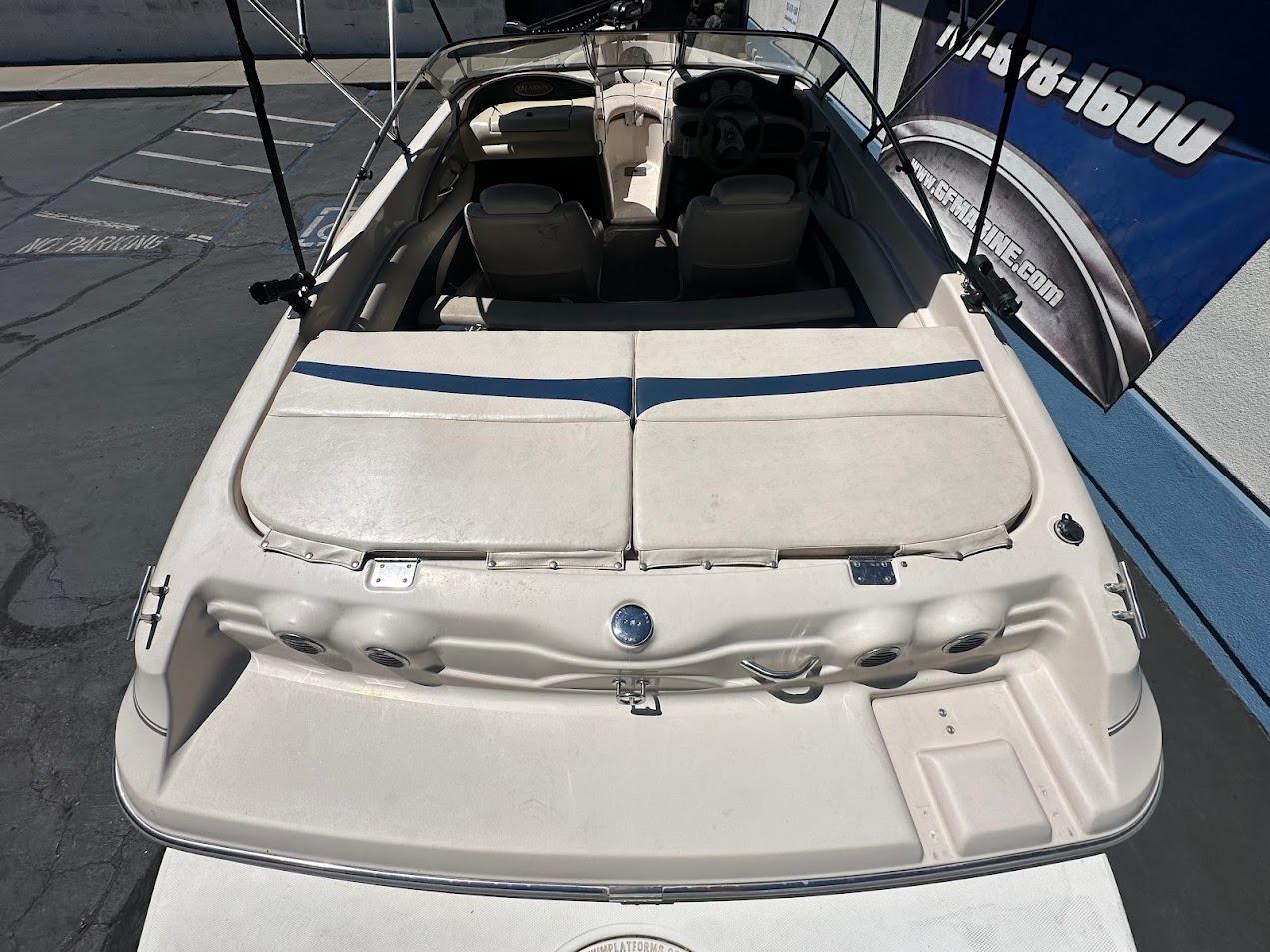 2001 Larson SEi 190 boat, rear view, parked outdoors, showcasing seating and deck area.