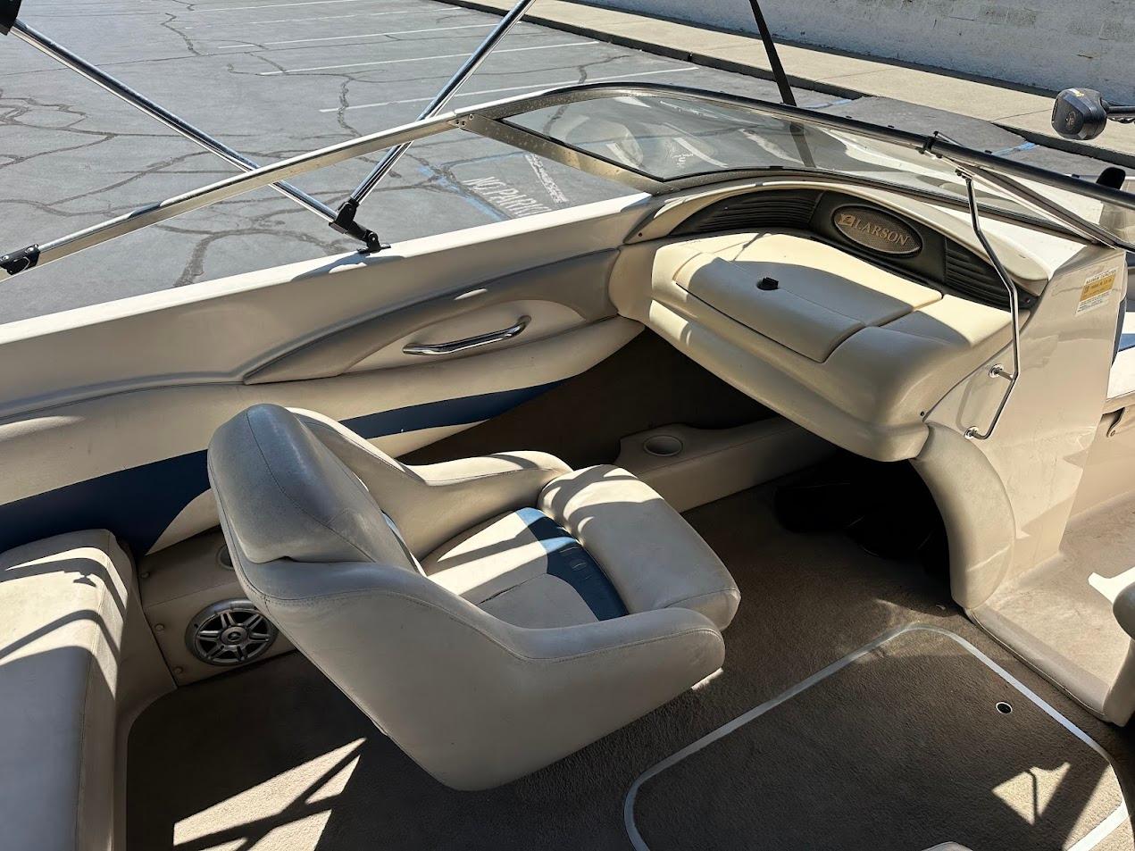 Interior of a 2001 Larson SEi 190 boat, featuring beige seating and dashboard.