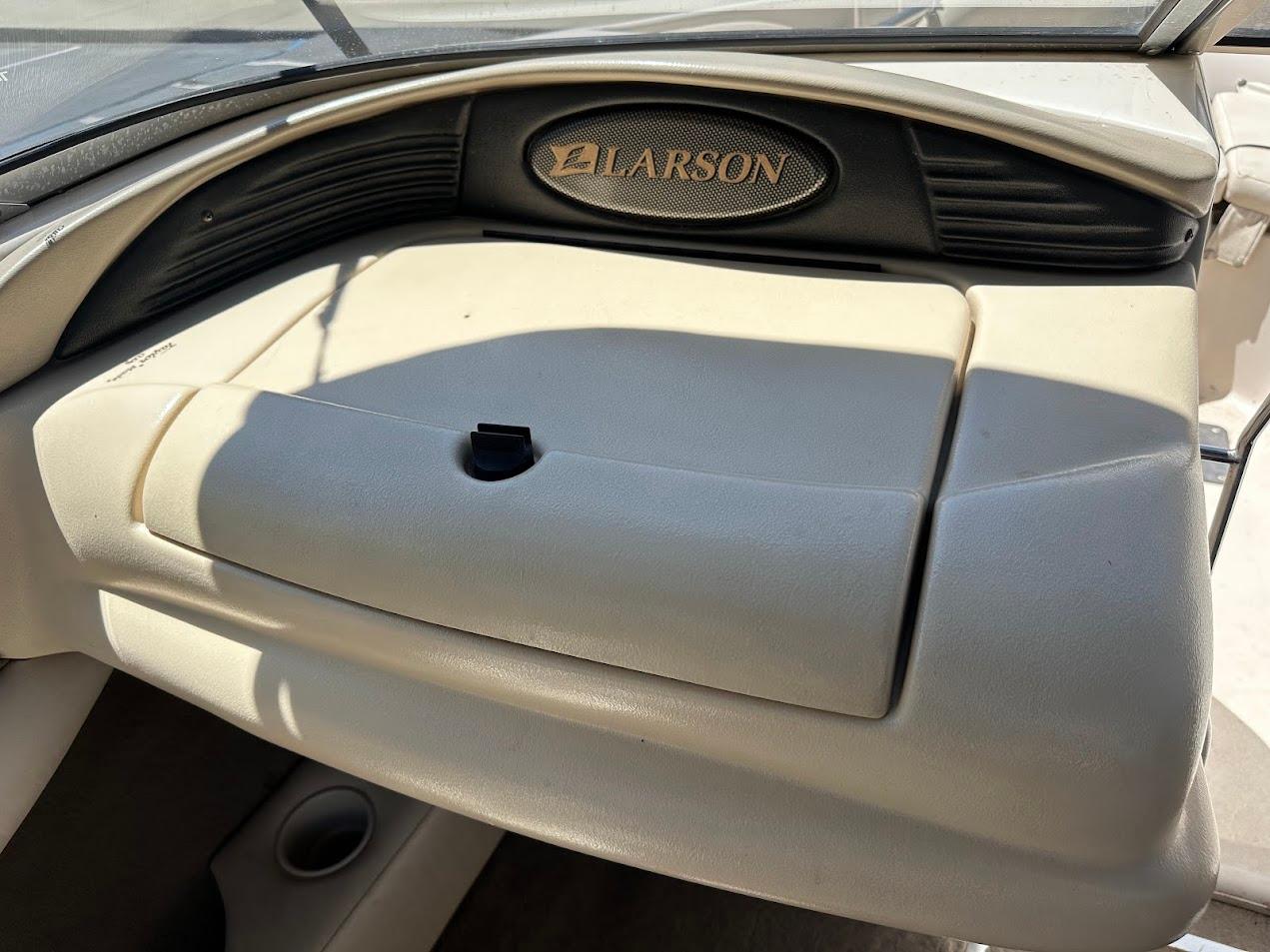 2001 Larson SEi 190 boat dashboard with glove compartment and logo.