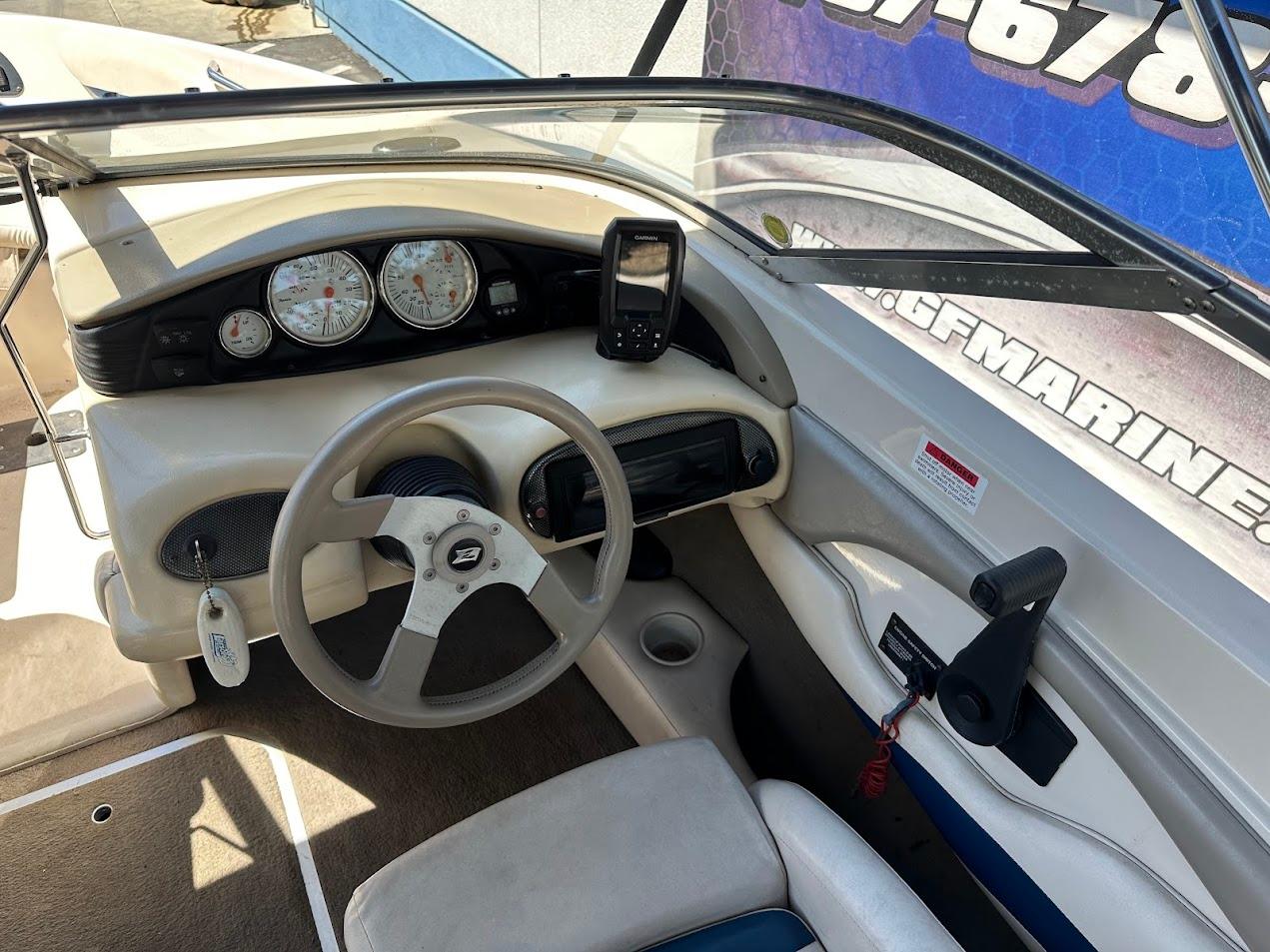 2001 Larson SEi 190 boat dashboard with steering wheel and gauges.