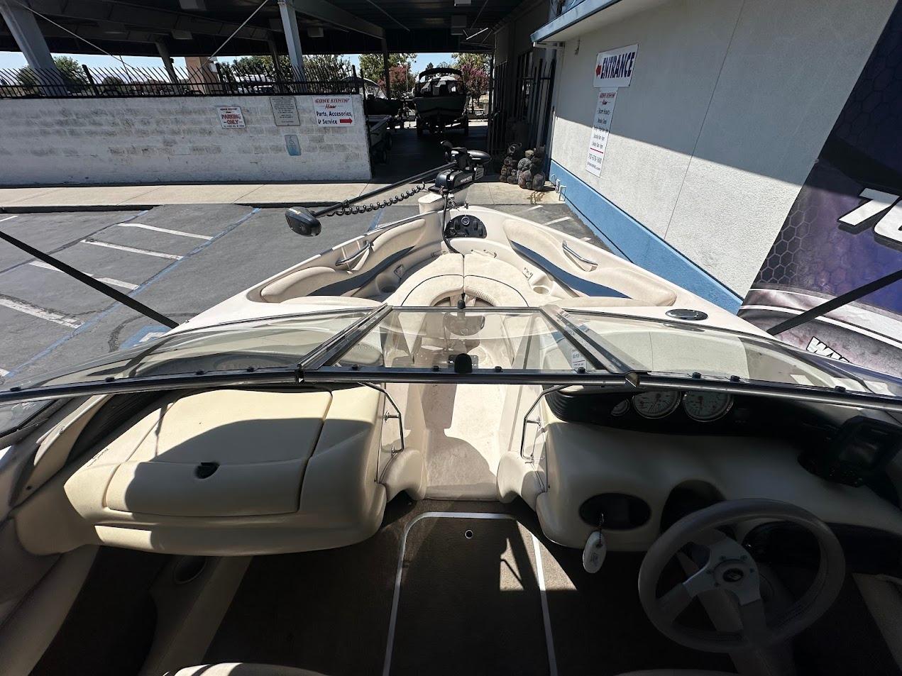 Interior view of a 2001 Larson SEi 190 boat, showcasing steering and seating area.
