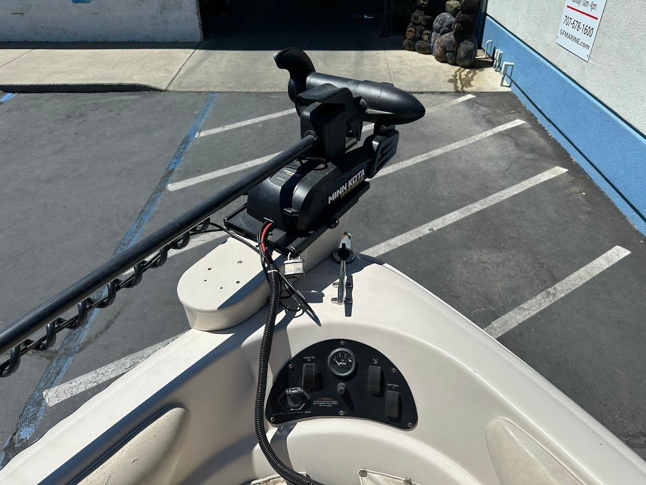 2001 Larson SEi 190 boat with Minn Kota trolling motor in parking lot.