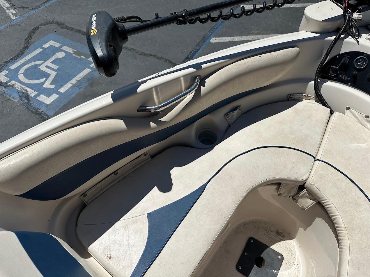 Interior of a 2001 Larson SEi 190 boat with seating and control panel.