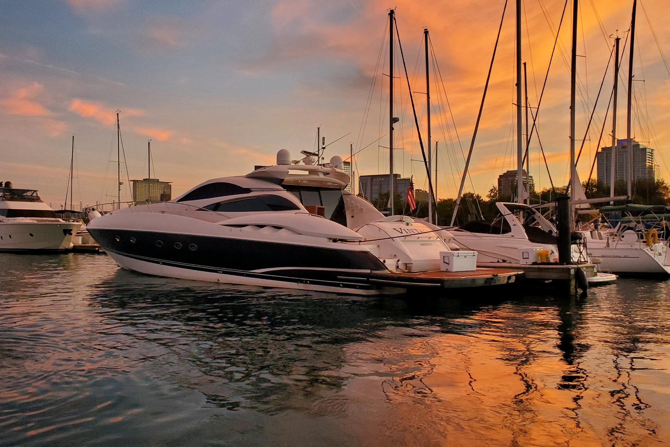 Sunseeker Predator 75 yacht docked at sunset, reflecting on calm water, 1999 model.