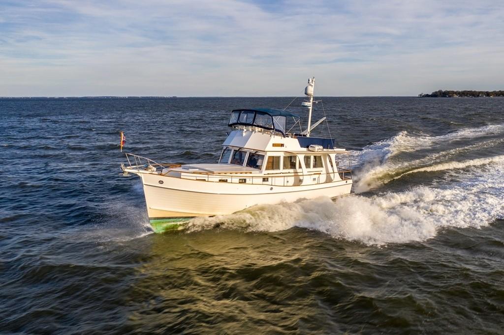 Grand Banks 46 Europa 2003 yacht cruising on open water, creating waves.