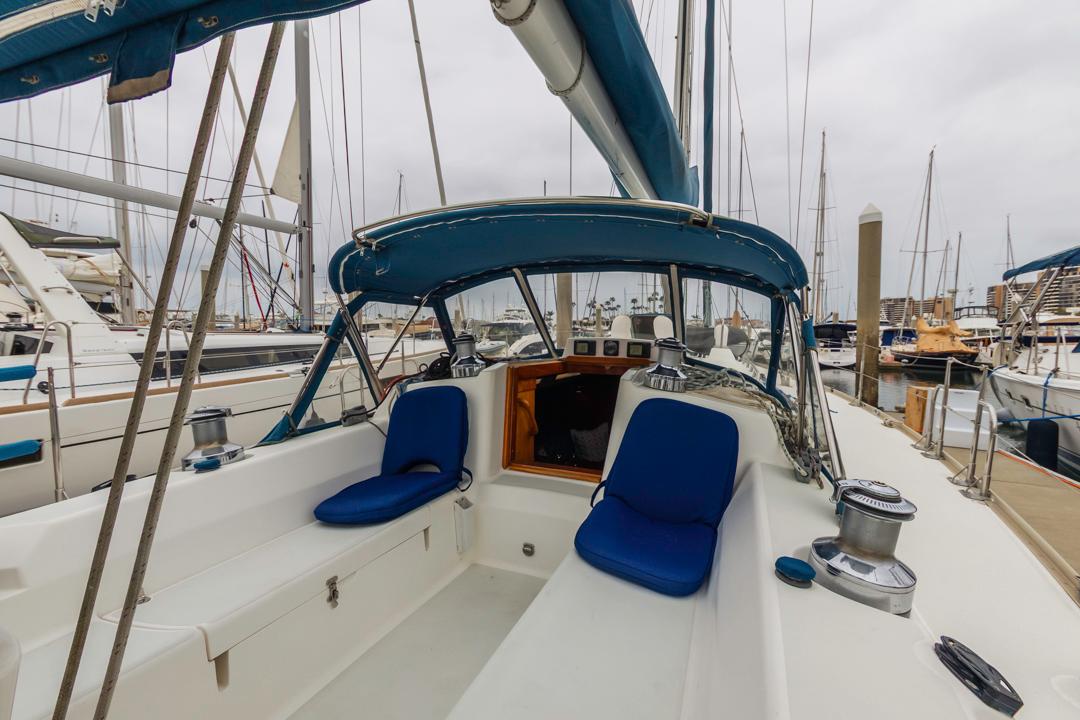 J Boats-46 2001-Lark US-Sailboat cockpit view, J Boats 46, 2001 model, with blue seating and marina background.-9774775 | Thumbnail