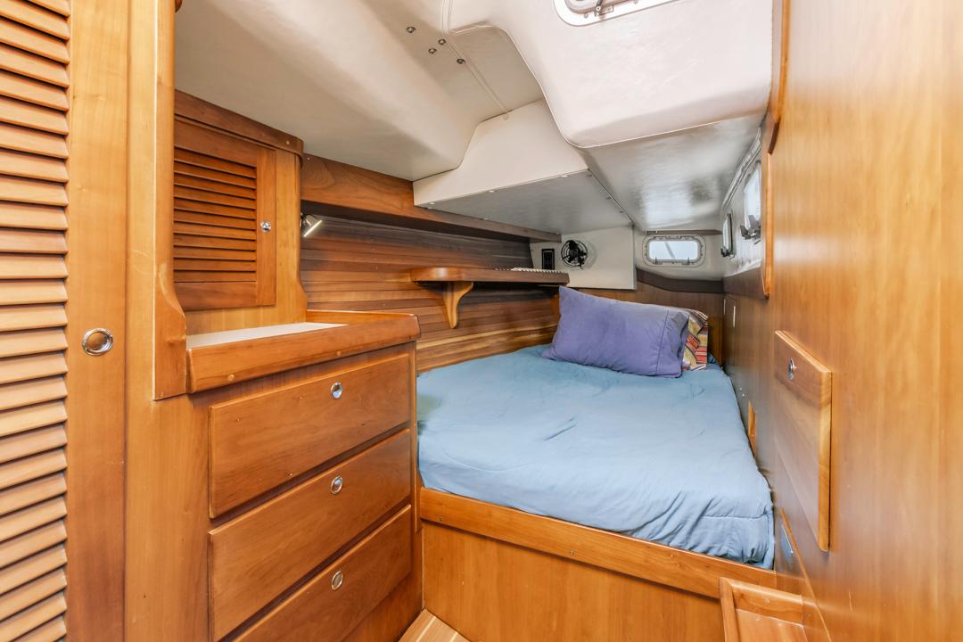J Boats-46 2001-Lark US-Cozy cabin interior of 2001 J Boats 46, featuring wooden cabinetry and a comfortable bed.-9774775 | Thumbnail