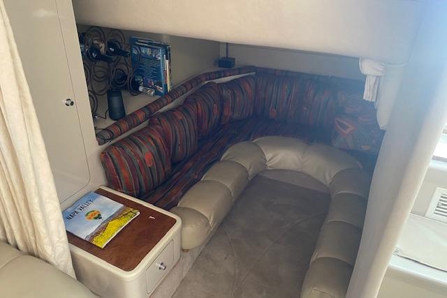Interior of a 1995 Regal 402 boat with cozy seating and storage.