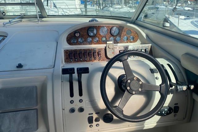 1995 Regal 402 boat dashboard with steering wheel and control panel.