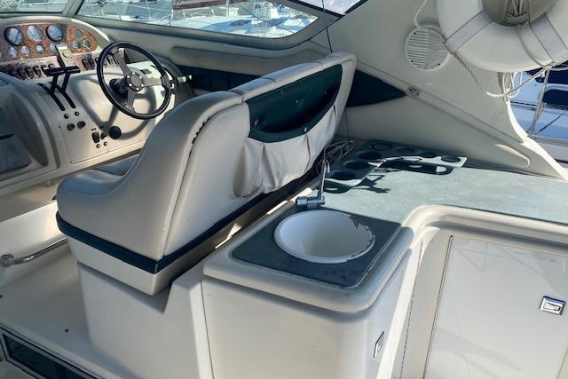 1995 Regal 402 boat interior with steering wheel, sink, and control panel.