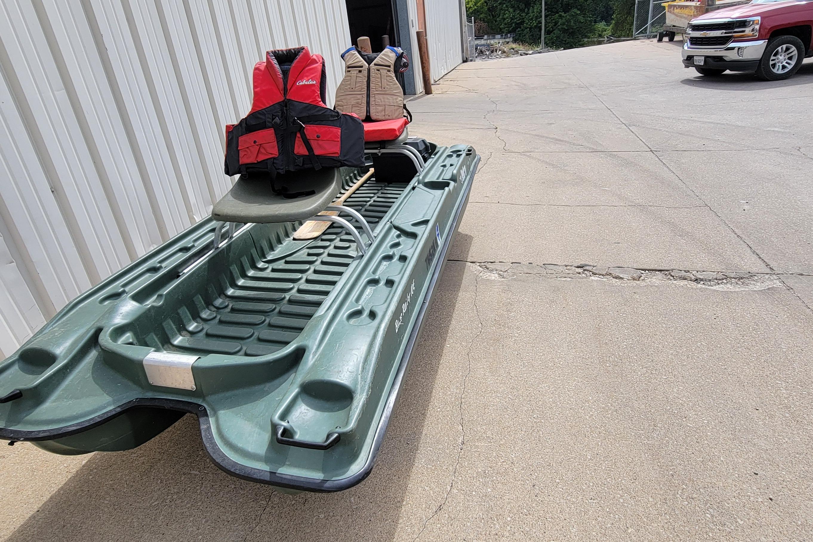 2007 Pelican Bass Raider 10 boat with life jackets on concrete surface.