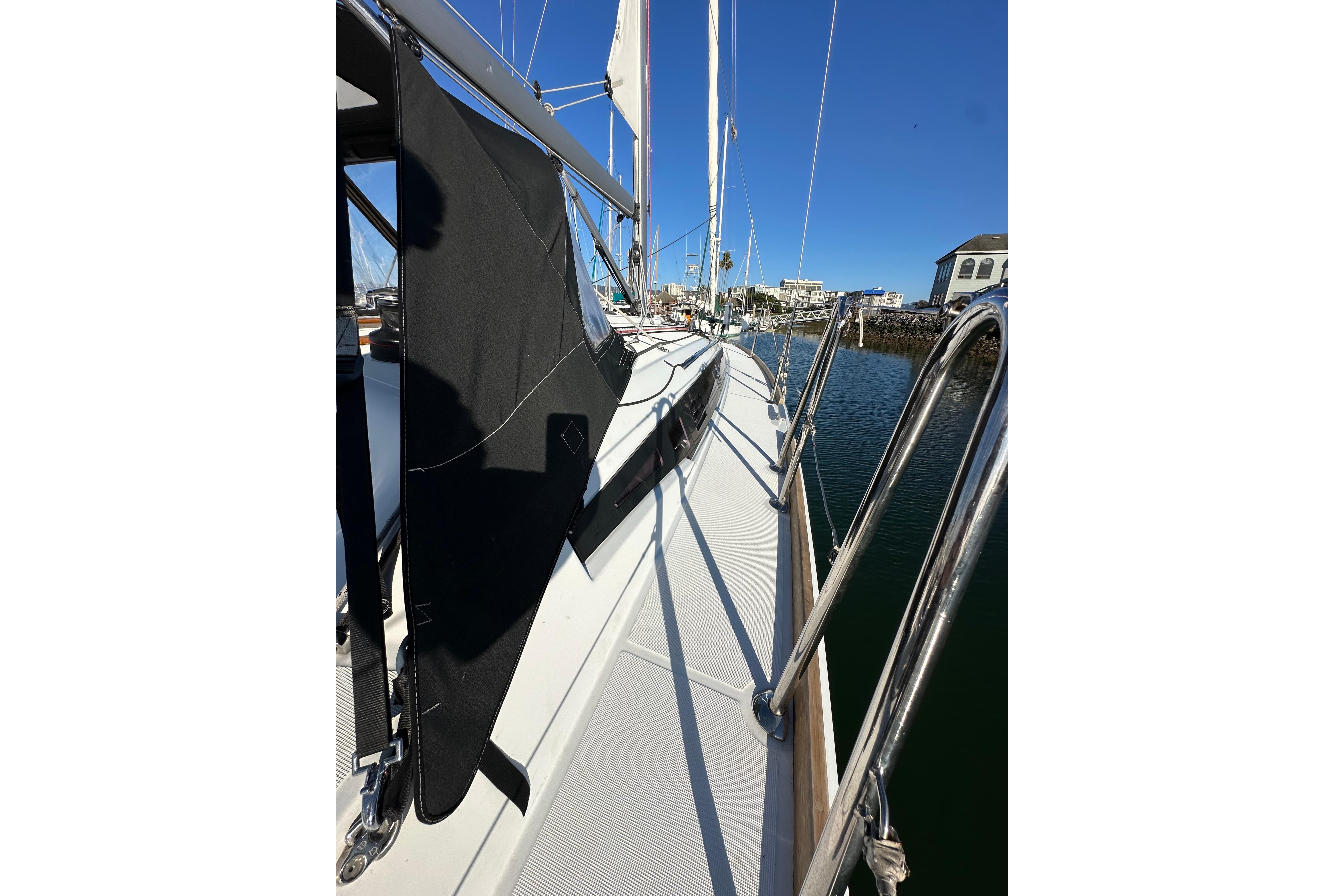 2021 Jeanneau Sun Odyssey 349 sailboat docked, showcasing sleek deck and railing design.