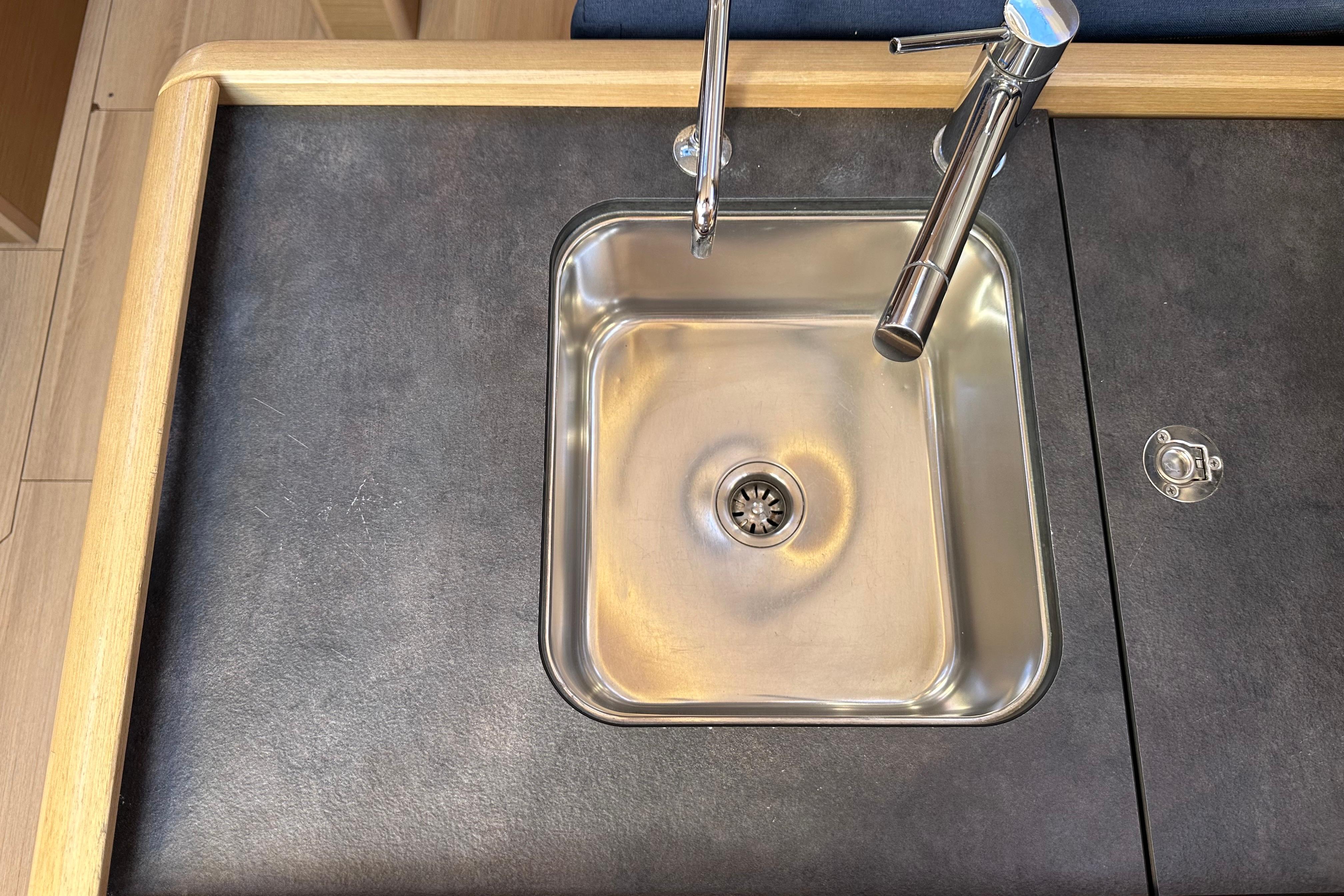 Stainless steel sink and faucet on Jeanneau Sun Odyssey 349 yacht, 2021 model.