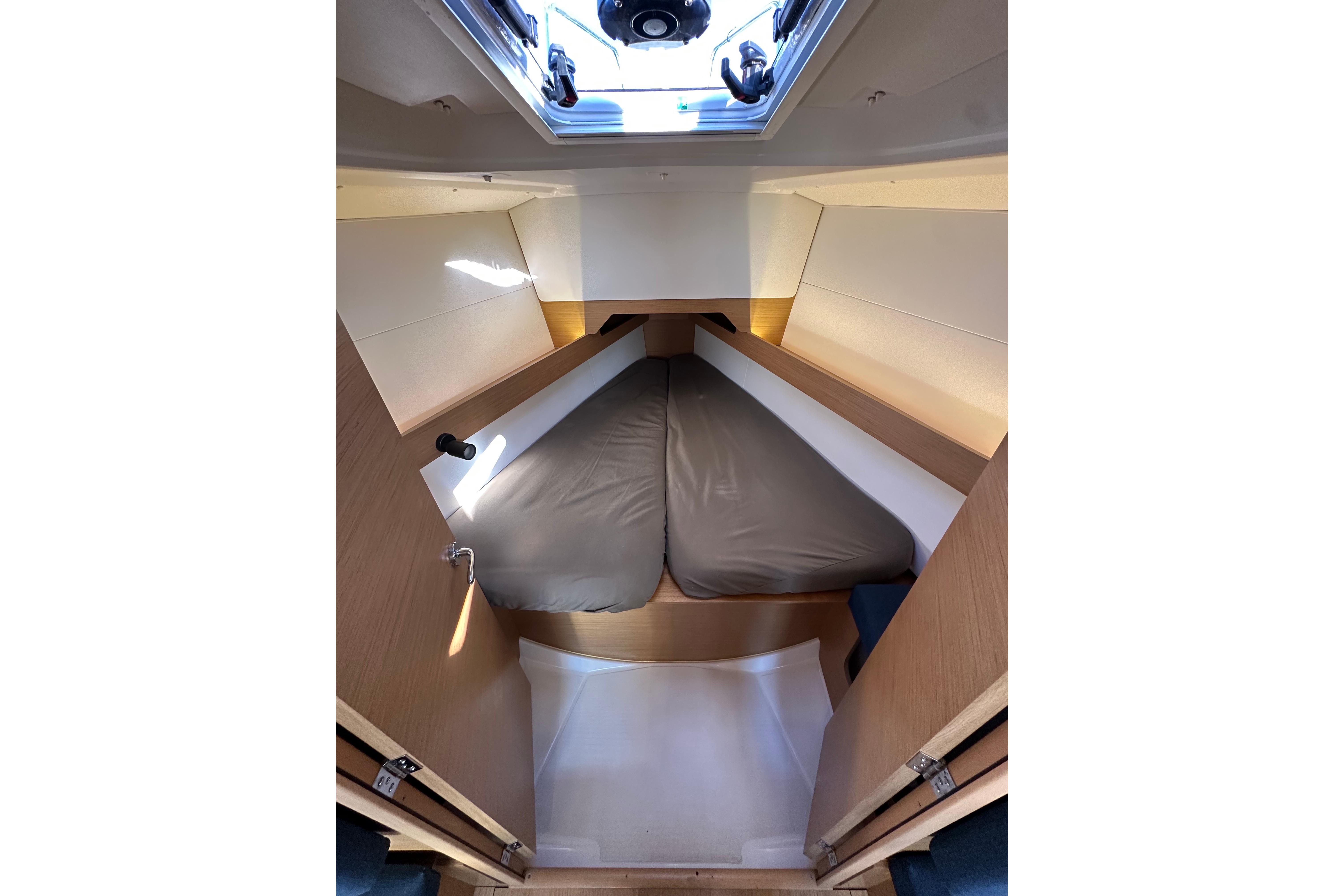 Interior cabin of 2021 Jeanneau Sun Odyssey 349 sailboat, featuring a cozy sleeping area.