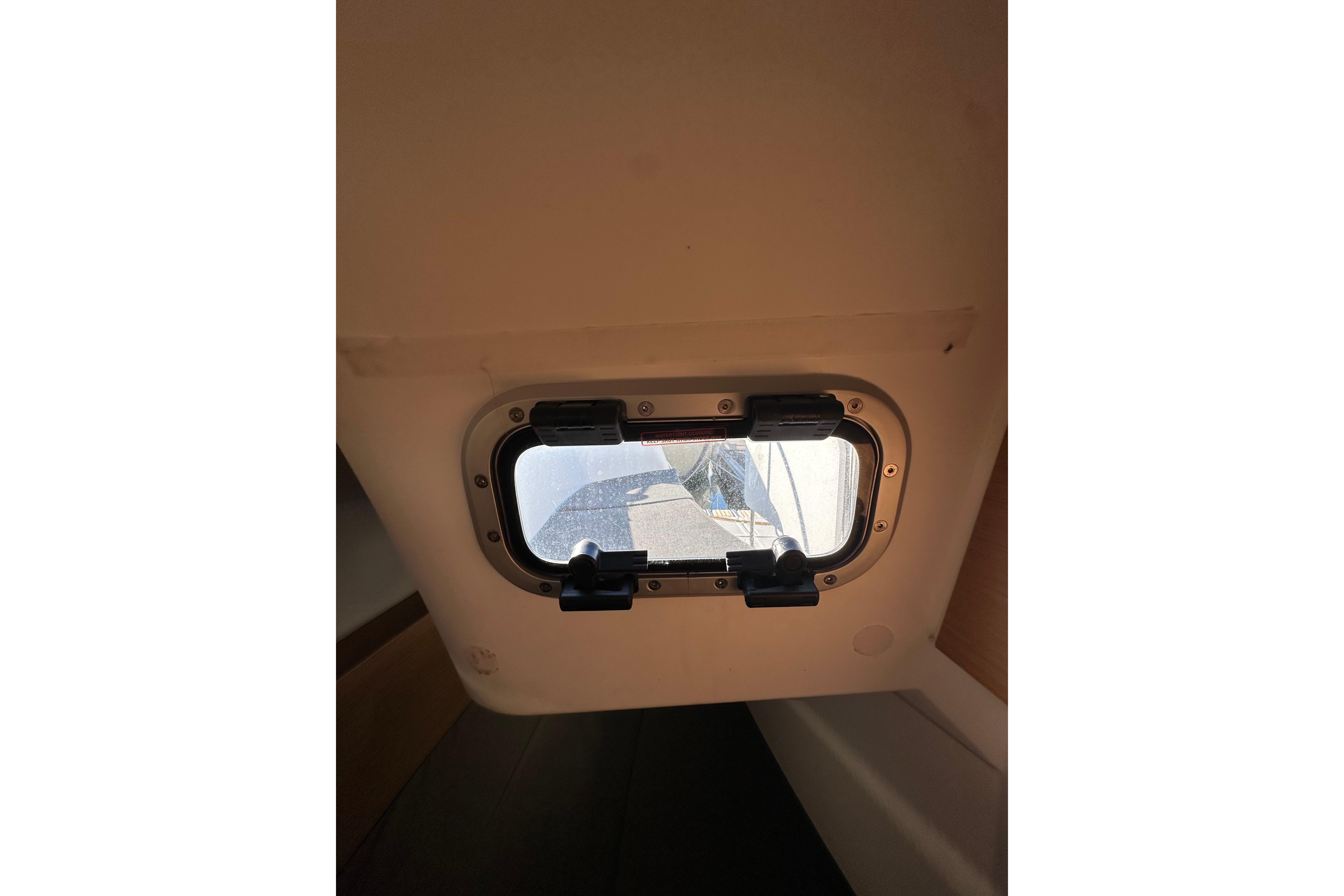 Cabin window view inside 2021 Jeanneau Sun Odyssey 349 sailboat.