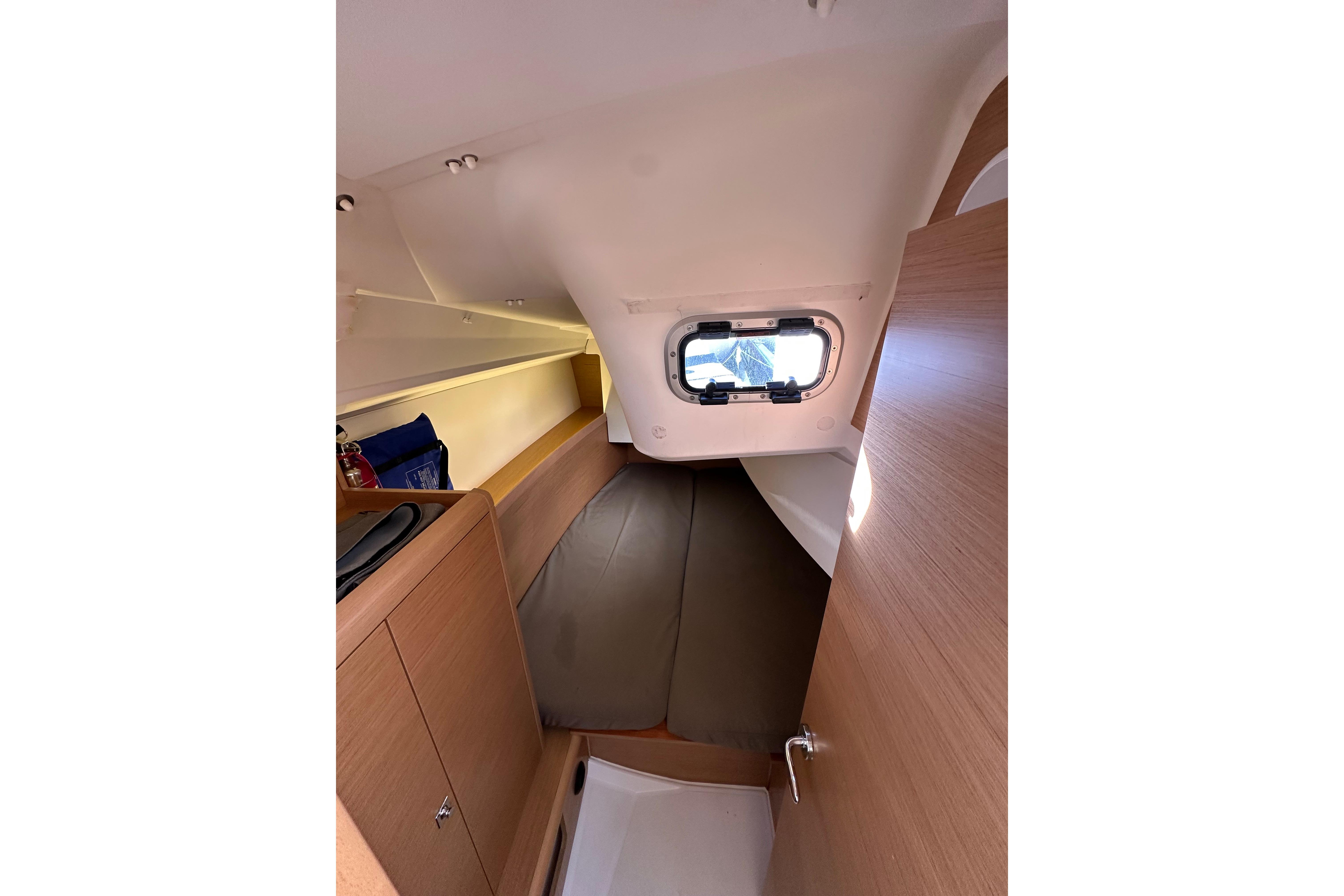 Interior cabin of 2021 Jeanneau Sun Odyssey 349 sailboat, featuring cozy sleeping area.